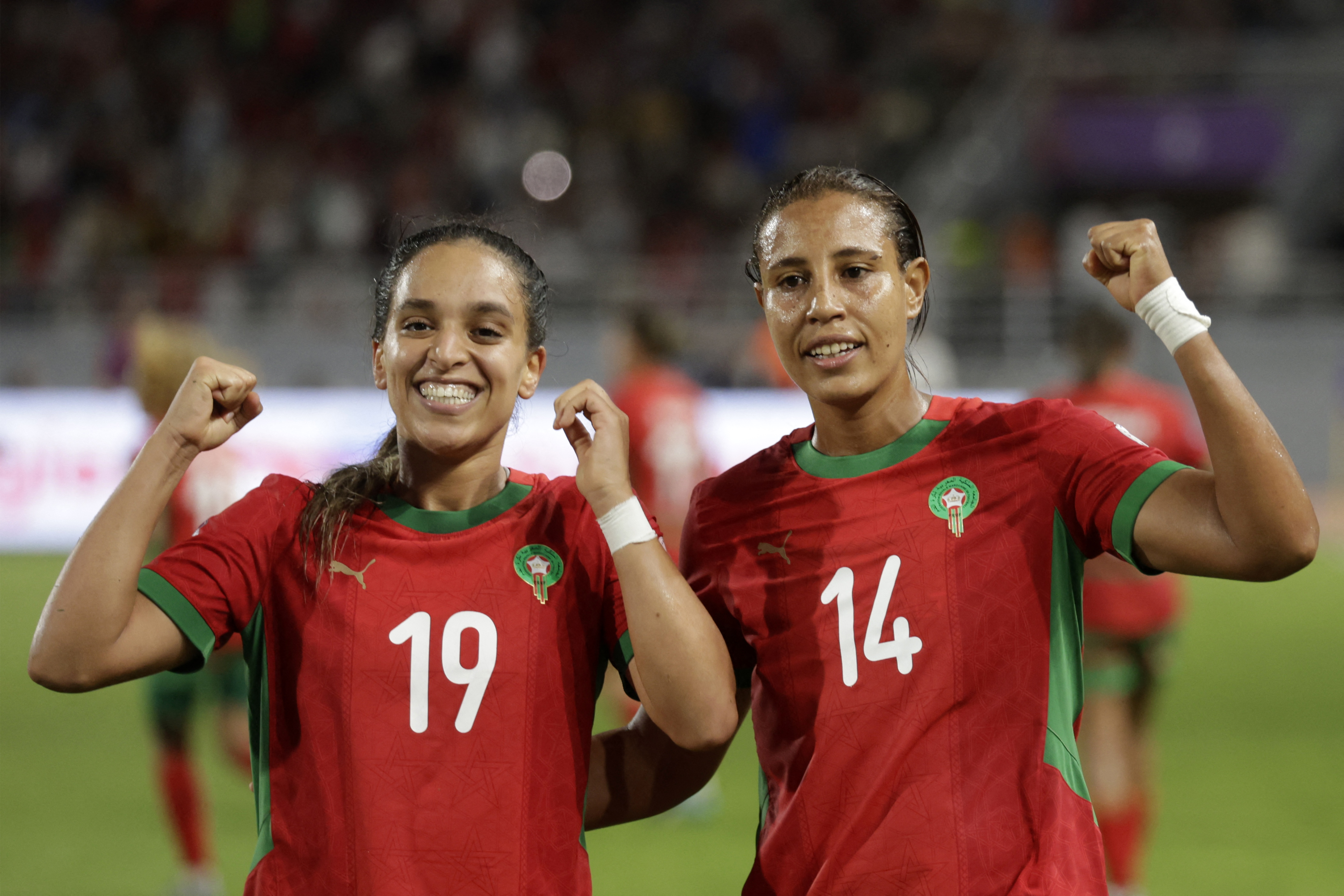 Morocco's forward #19 Sakina Ouzraoui celebrates with defender #14 Aziza Rabbah after scoring her team's equaliser during the 2025 Women's Africa Cup of Nations semi-final football match against Ghana