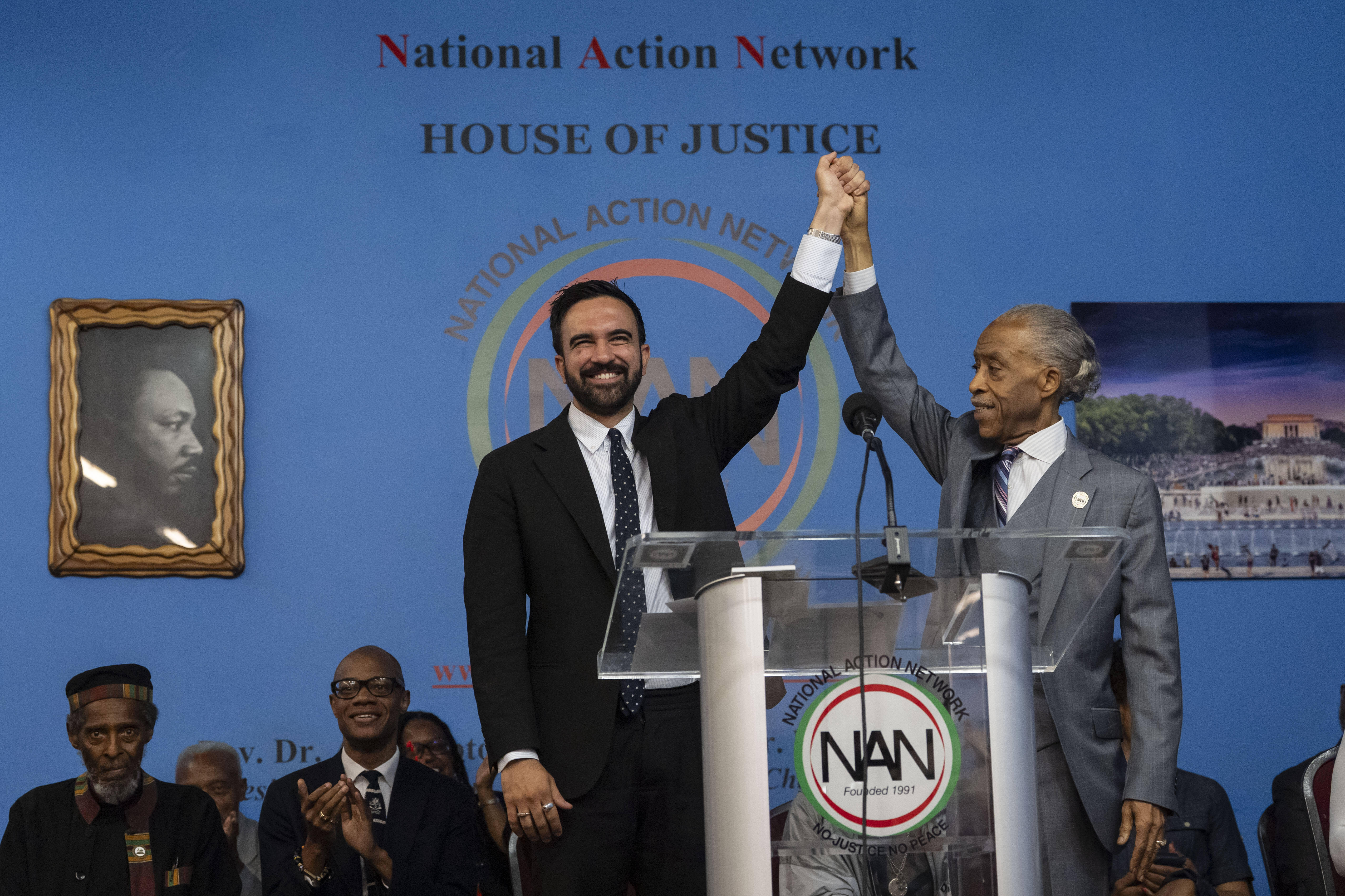 Reverend Al Sharpton raises the hand of Democratic mayoral candidate Zohran Mamdani during a rally for the National Action Network