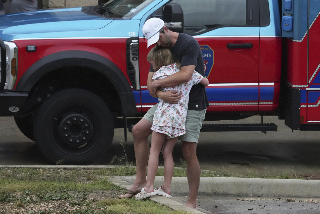 People are reunited at a centre in Ingram town after flash floods hit Texas on July 4