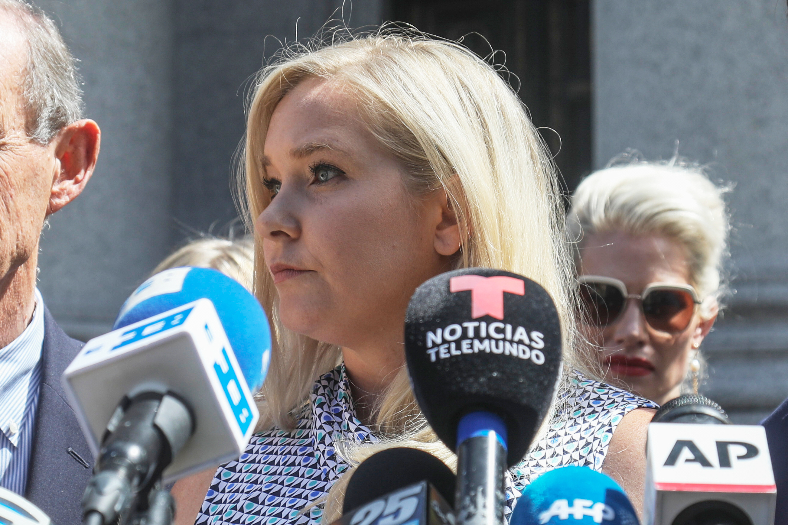 Virginia Giuffre speaks at an outdoor news conference.