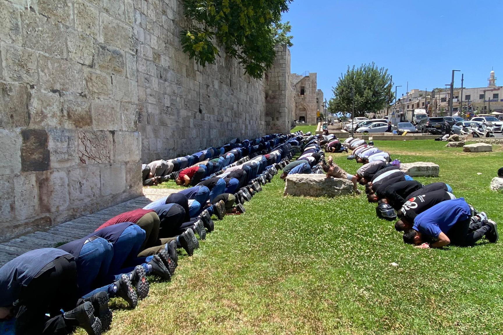 Muslims pray outside the walls of the Old City of Jerusalem during the 12-day war with Iran, due to restrictions imposed by the Israeli authorities [Al Jazeera]