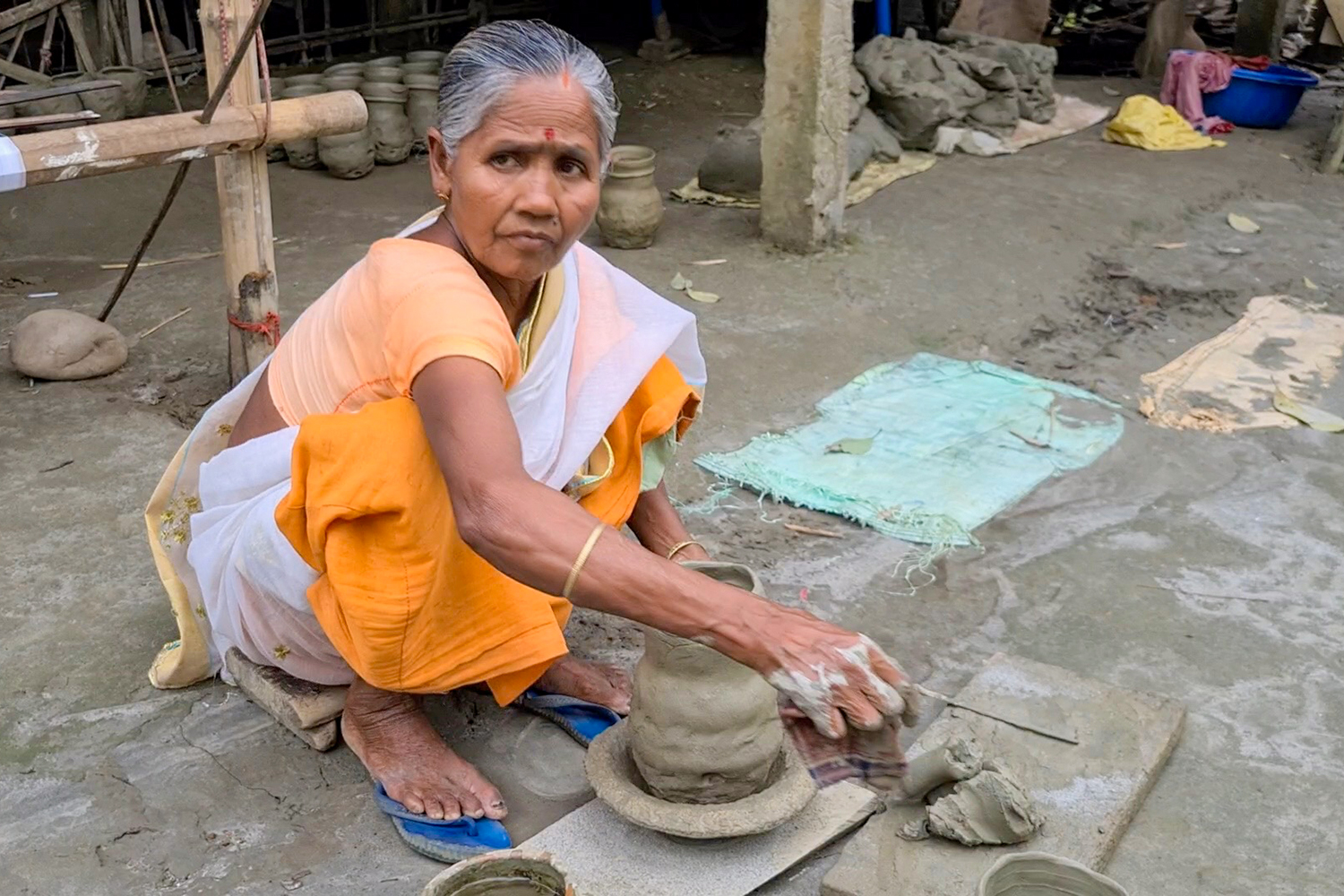 Makon Kumar sculpts a Tekele, a small sized pot used to carry milk