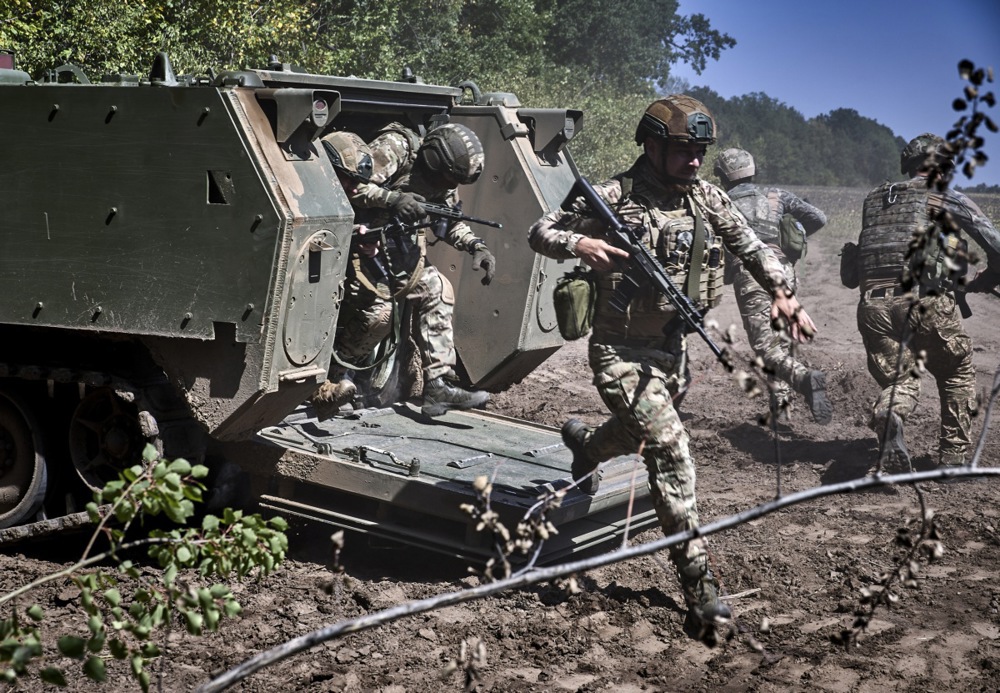 Ukrainian servicemen of the 13th Operational Brigade of the Ukrainian National Guard attend training, including practicing landing and loading into an American M113 armored personnel carrier at a shooting range in the Kharkiv region, Ukraine, 29 August 2025, amid the ongoing Russian invasion. EPA/SERGEY KOZLOV