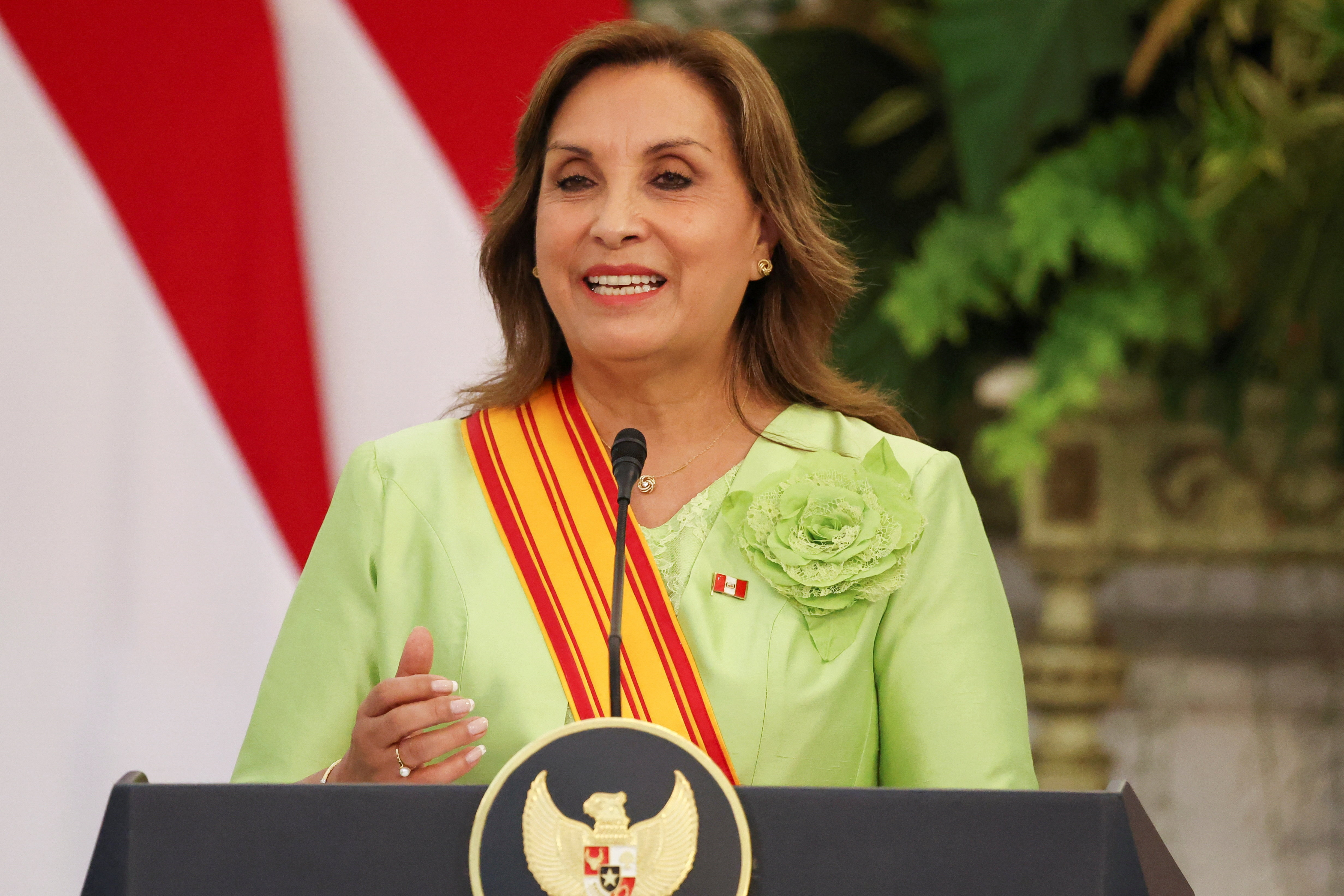 Dina Boluarte at a podium in Indonesia