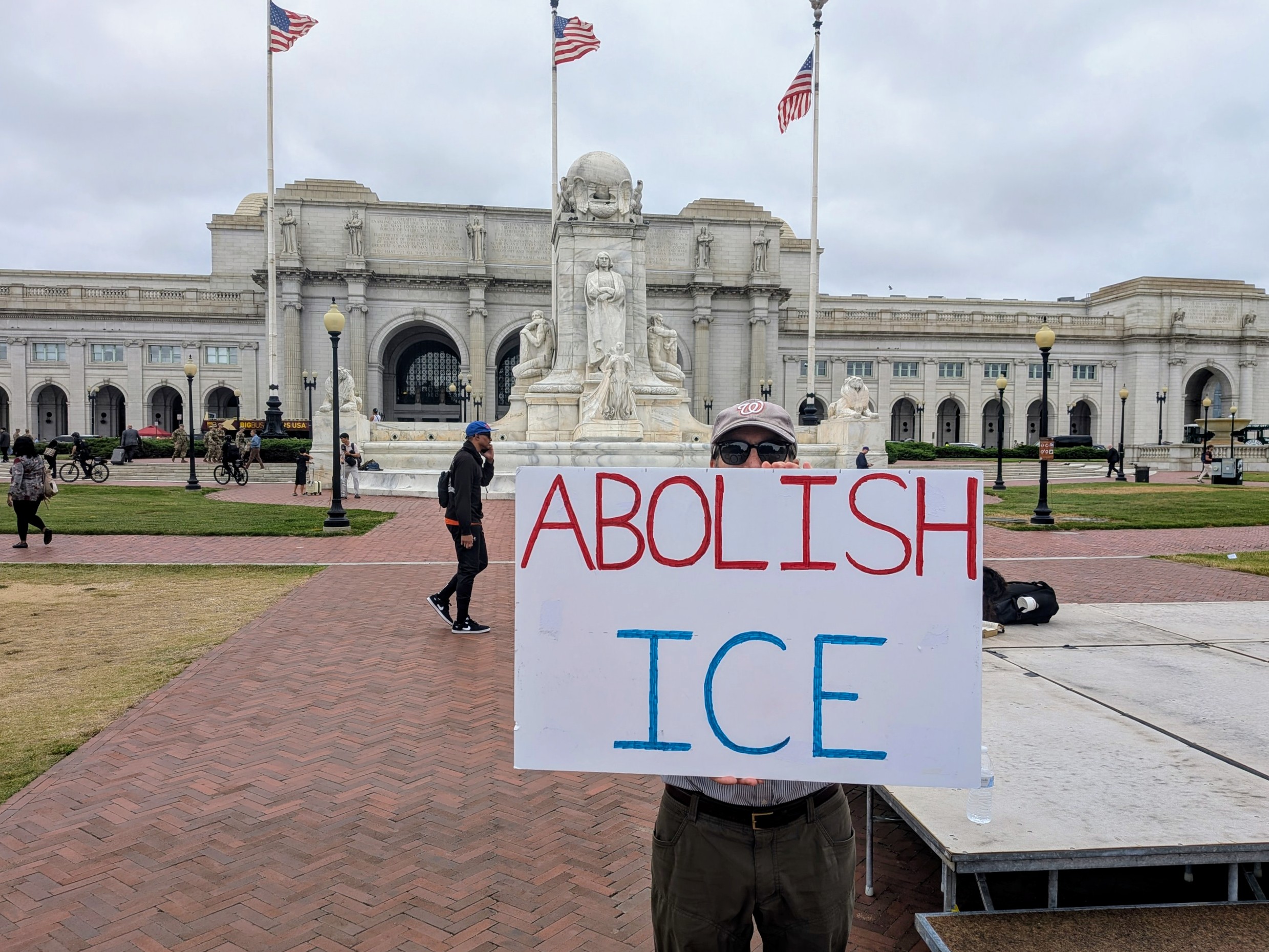 A demonstrator holds a one-person protest outside Union Station on August 21, 2025