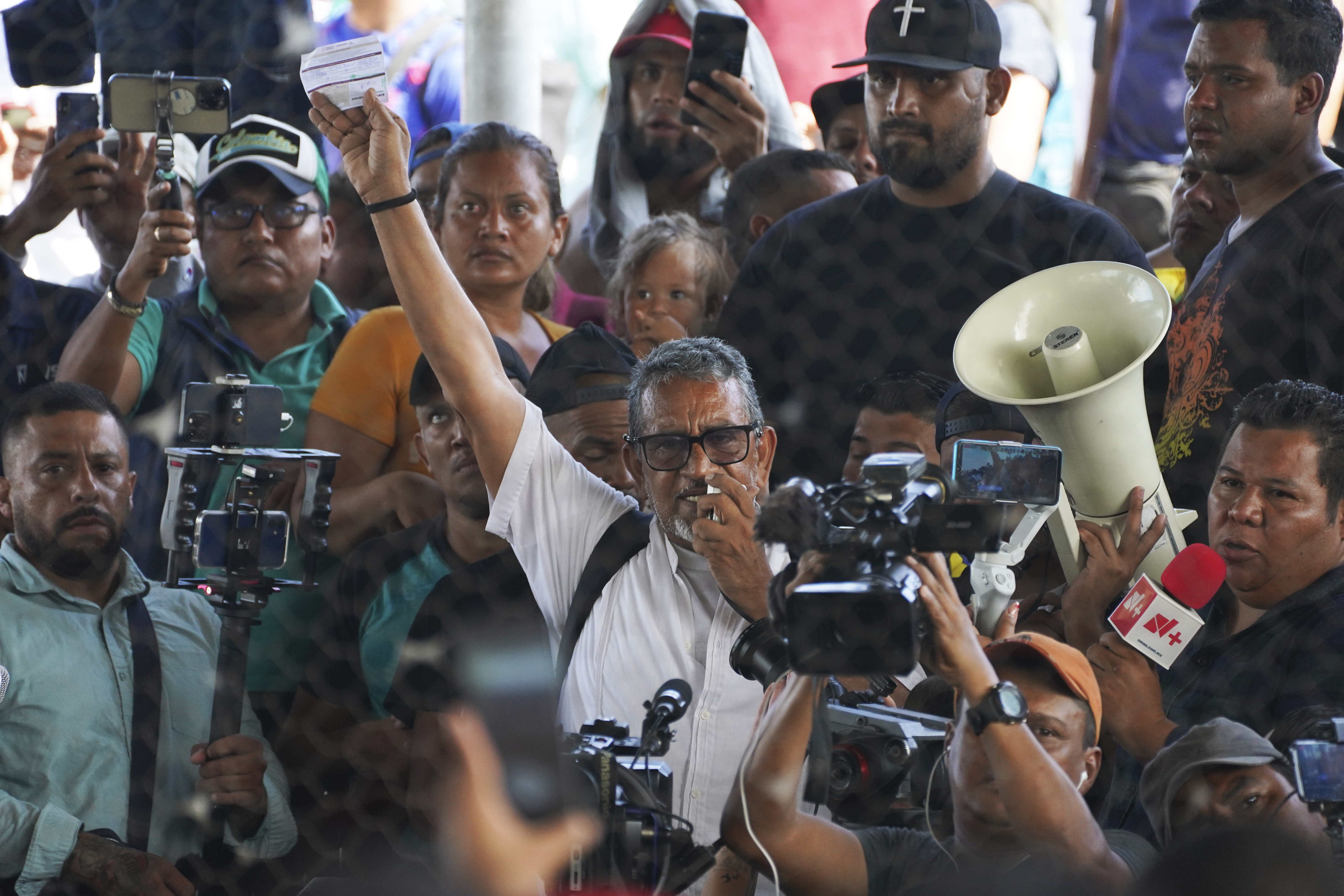 Luis Garcia Villagran, the coordinator for the Centre for Human Dignification AC, speaks to migrants through a megaphone at a shelter in Huixtla, Mexico, on June 8, 2022