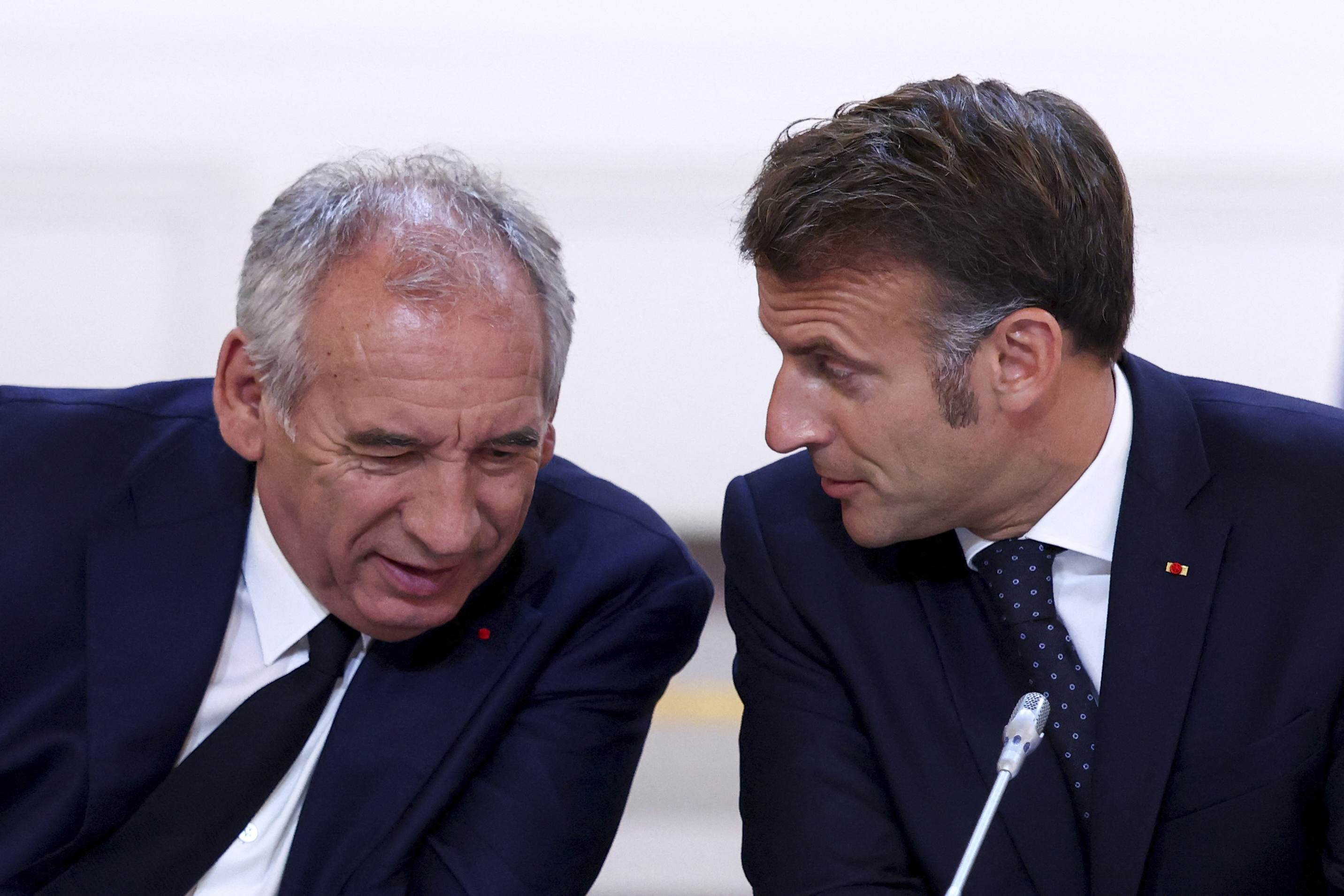 FILE -French President Emmanuel Macron, left, and Prime Minister Francois Bayrou attend a meeting with New Caledonia's elected officials and state representatives who have concluded a historic agreement allowing the creation of a "State of New Caledonia" within the French Republic, at the Elysee Palace in Paris, July 12, 2025. (Tom Nicholson, Pool Photo via AP, File)