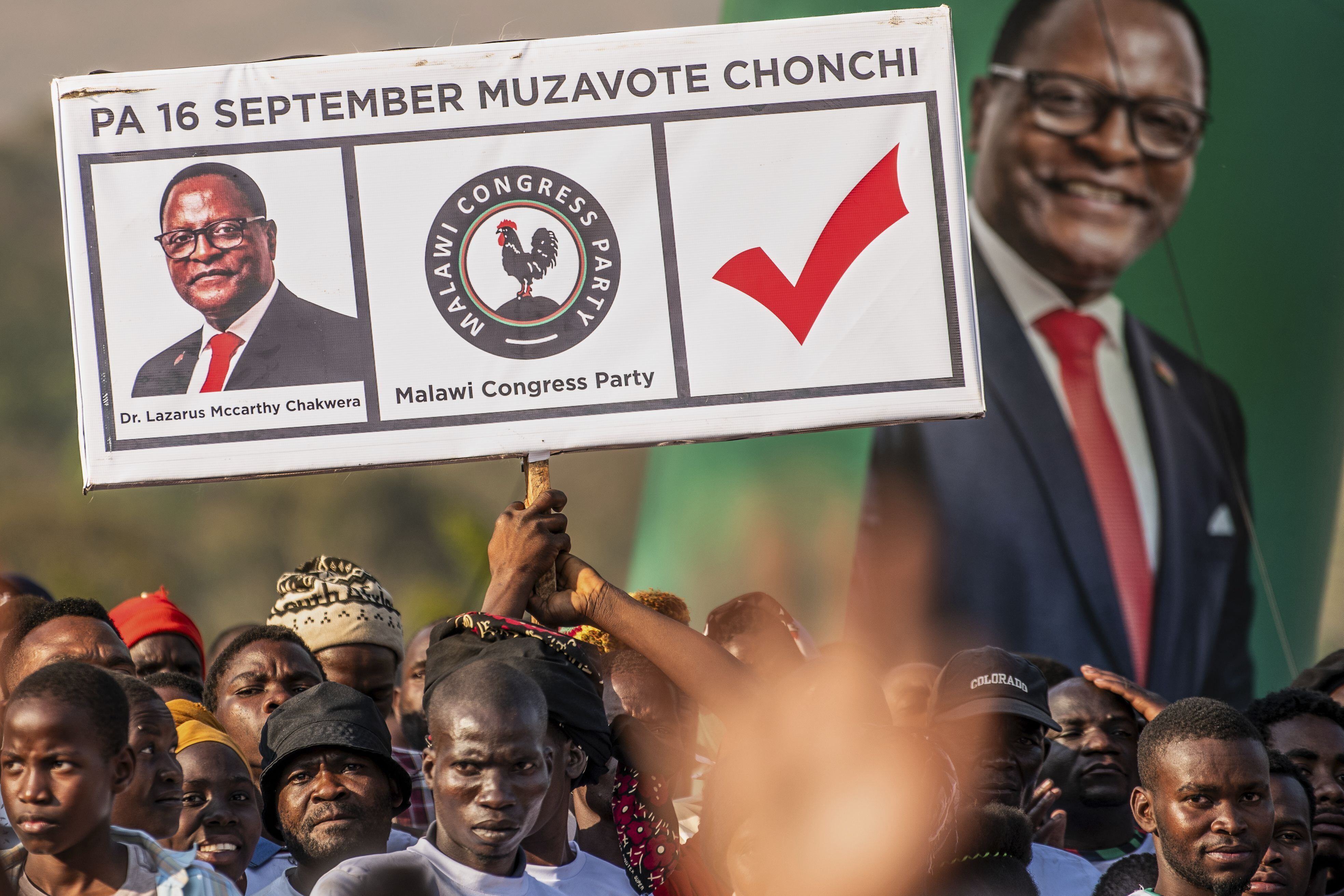 Malawi Congress Party supporters hold a poster showing President Lazarus Chakwera at a campaign rally in Blantyre, on September 7, 2025