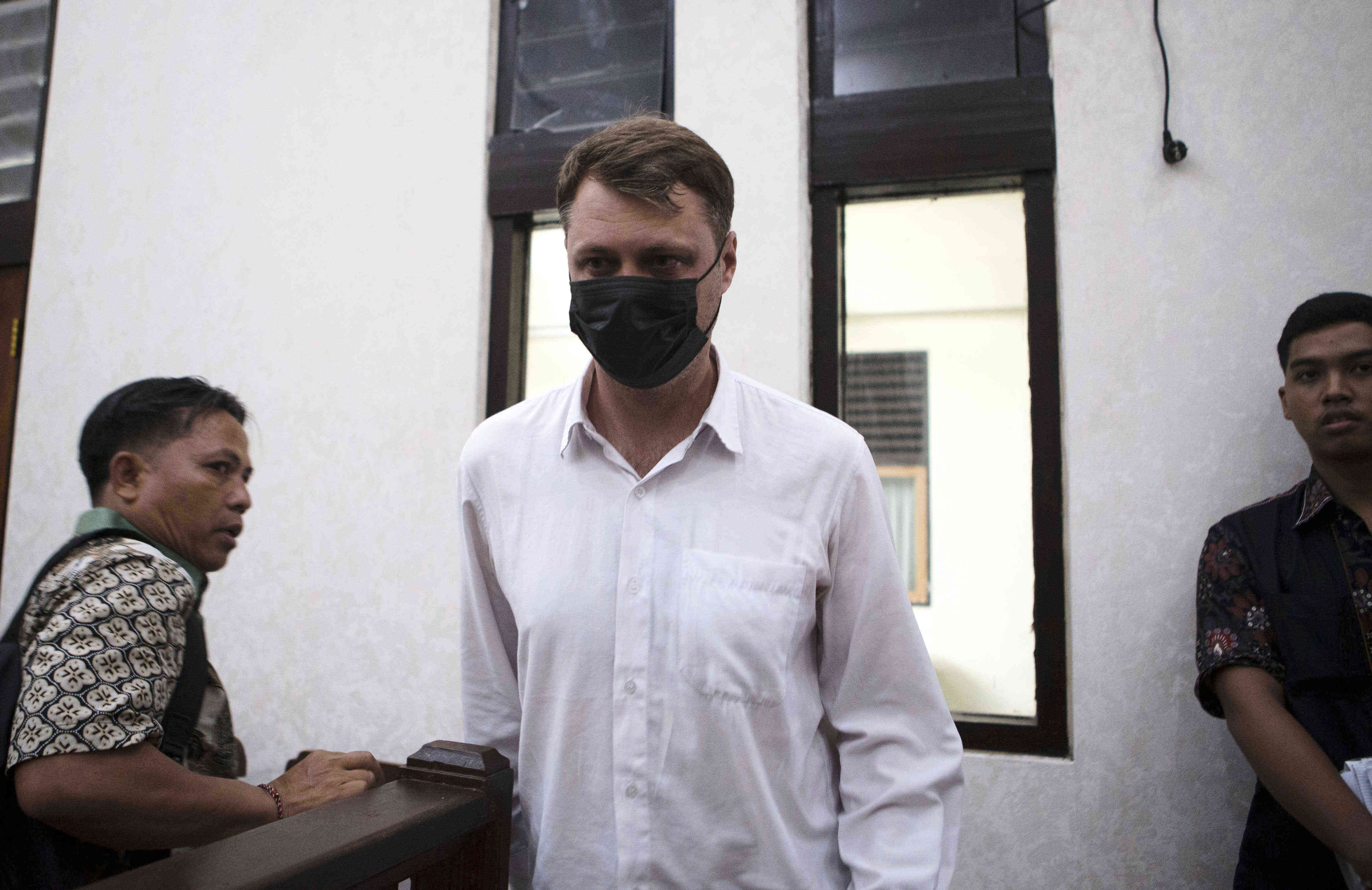 Ukrainian Roman Nazarenko, center, arrives for a hearing at the court.