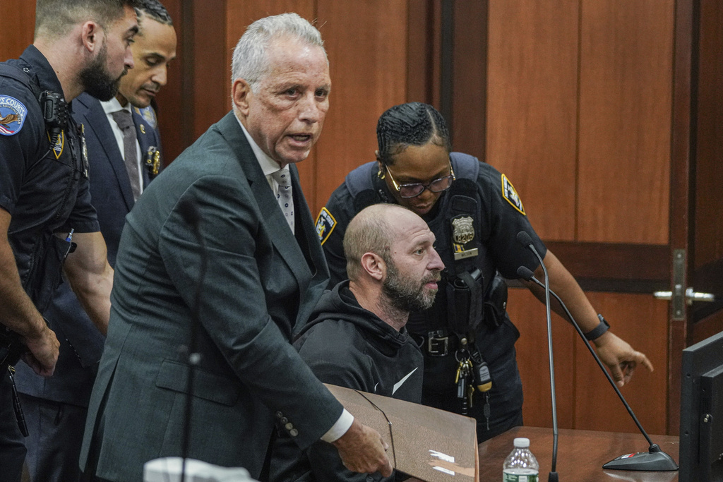 Jeremy Fistel, right, sits at the defence table with his attorney Todd Douglas Greenberg, during his arraignment in Queens Criminal Court, September 18