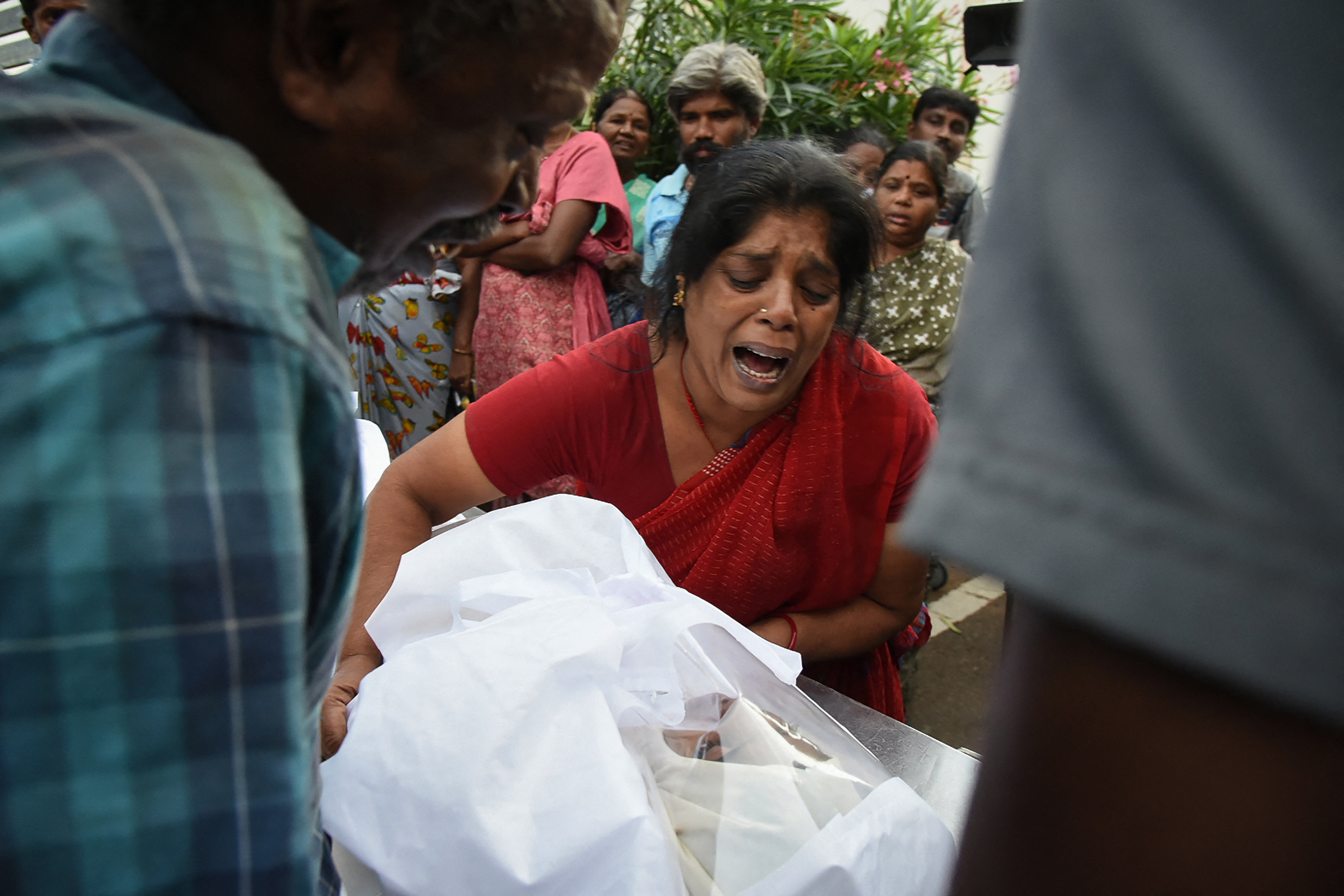 Relatives mourn after receiving the body of a victim who was killed in the stampede in Tamil Nadu, India