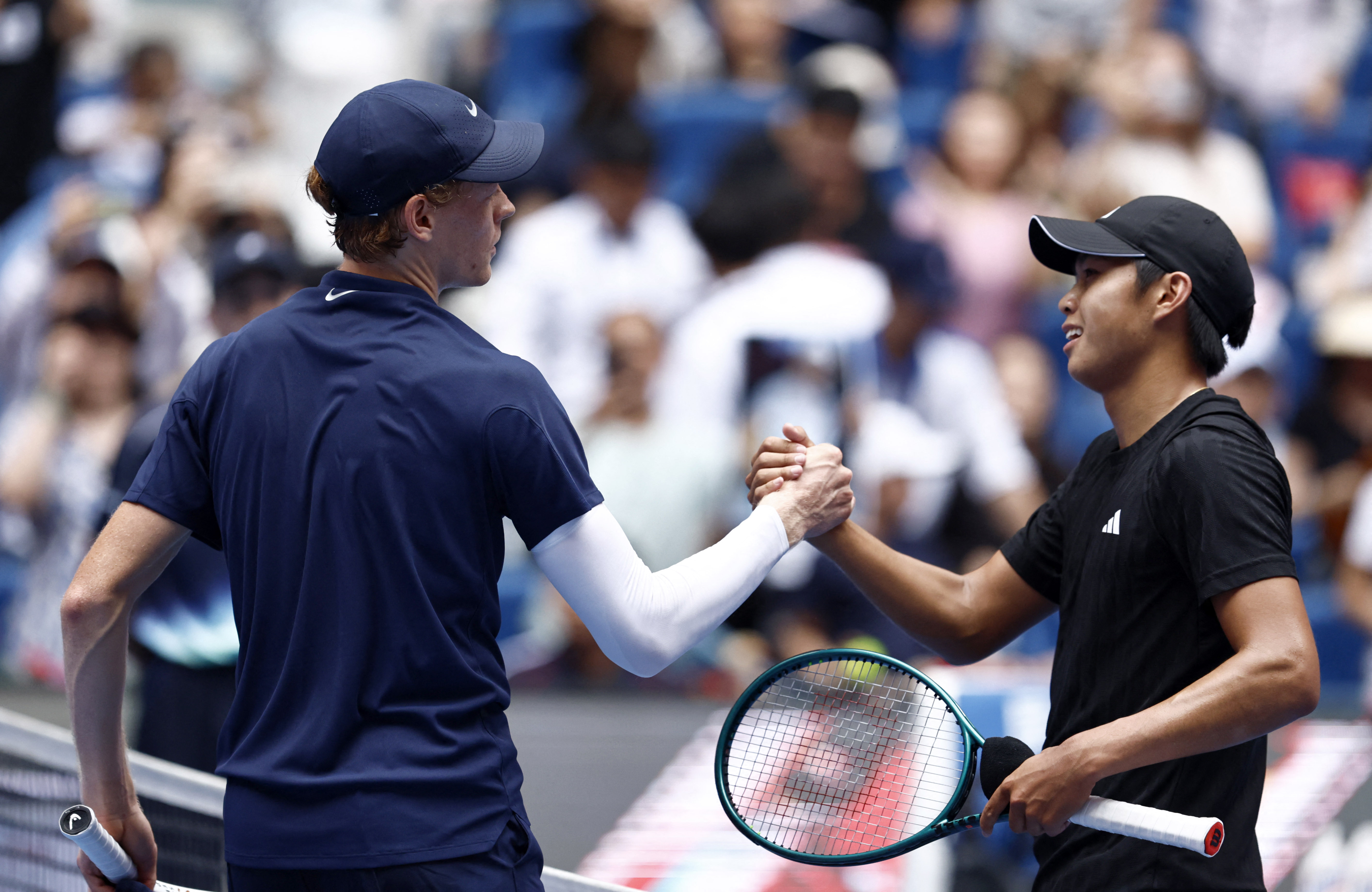Sinner, left, shakes hands with Tien after winning the China Open final