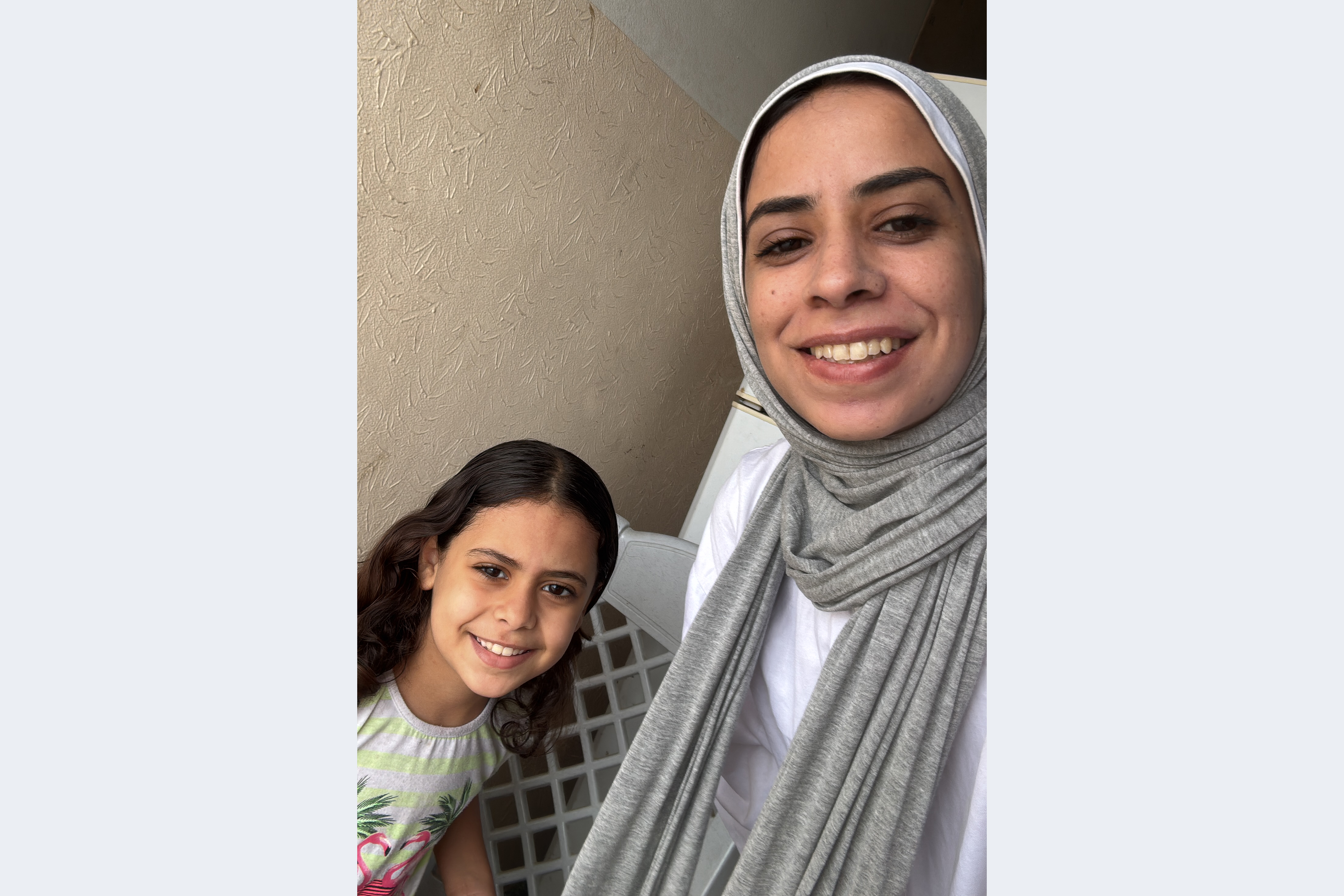 Maram Humaid, right, with her daughter Banias, left, at home in Deir el-Balah, Gaza, just after the ceasefire was announced [Courtesy of Maram Humaid]