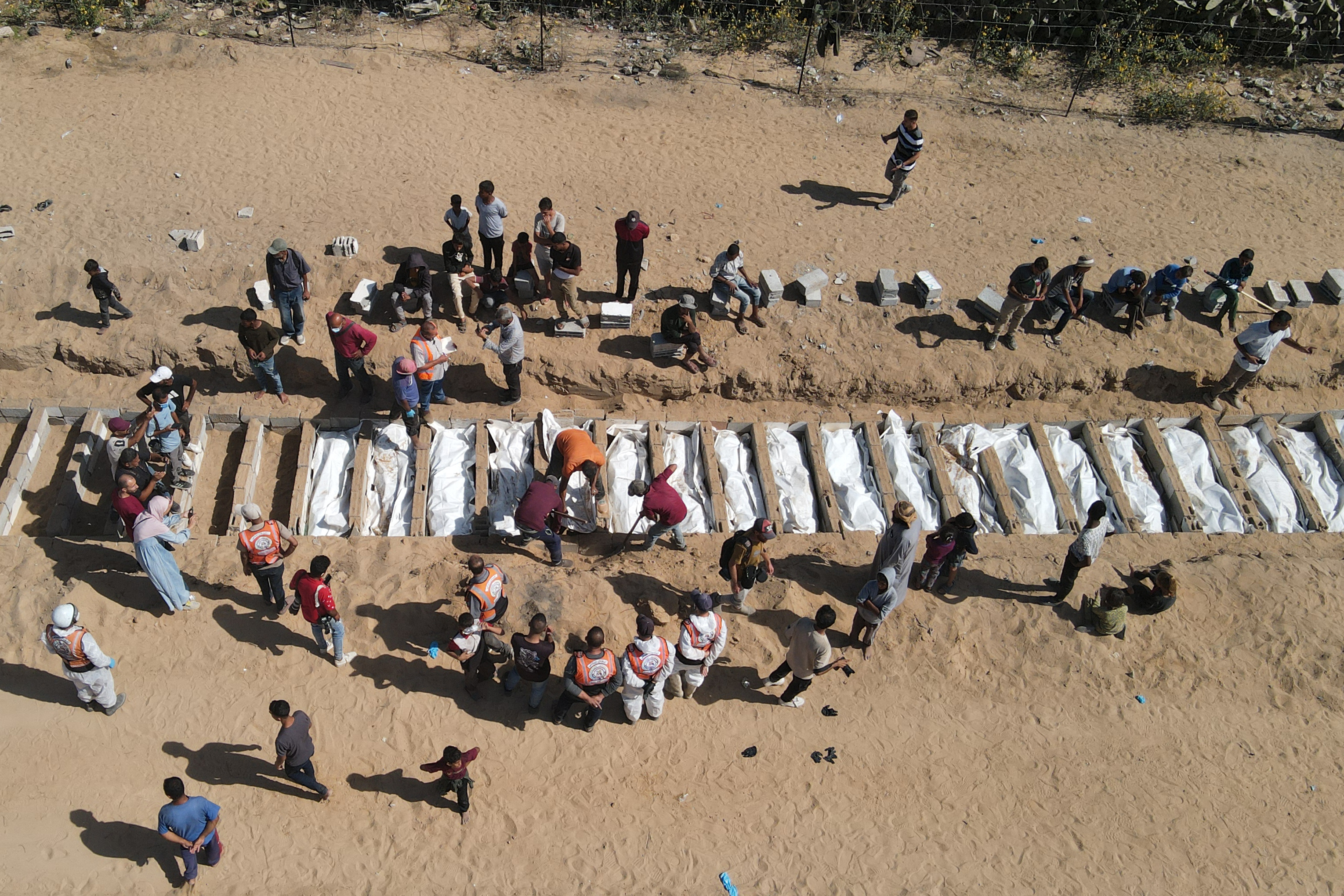 Families mourn as mass burial held for unidentified Palestinians in Gaza