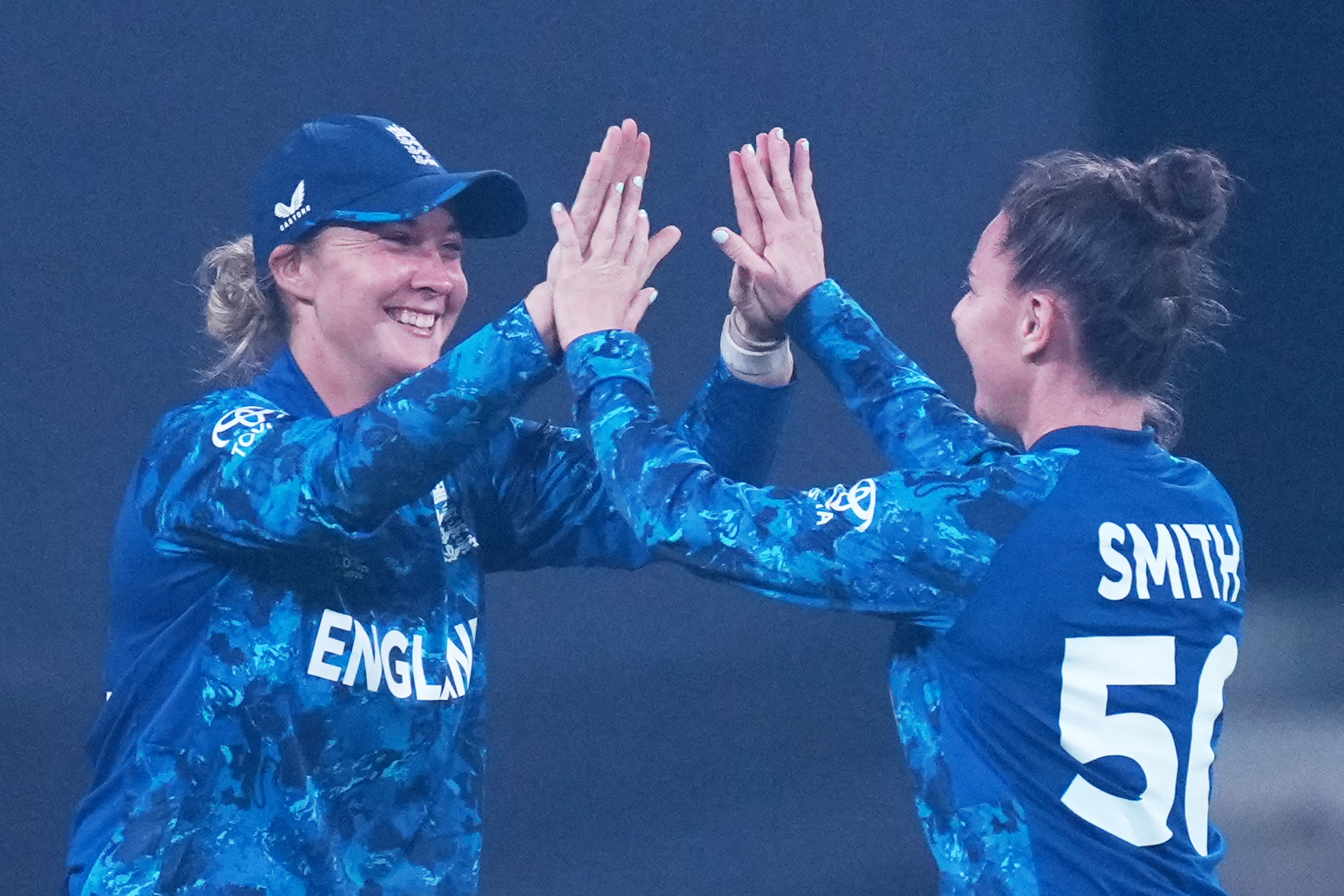 England’s Linsey Smith, right, celebrates after taking the key wicket of Mandhana for 88 during the India run chase