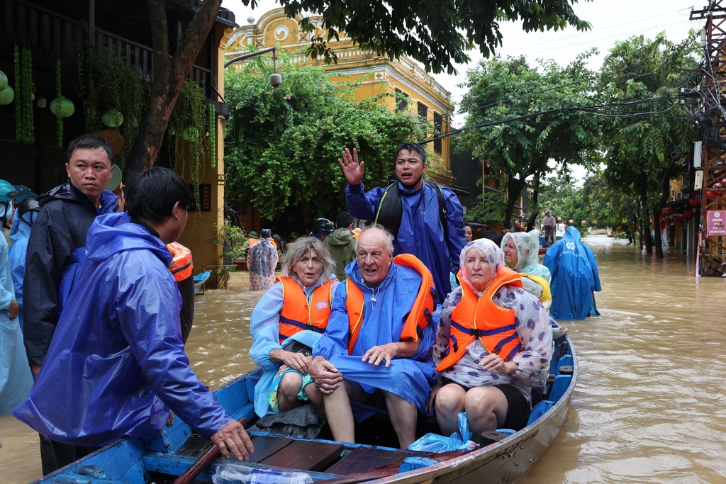 Tourists are evacuated by boat from Hoi An, Vietnam, on October 28, 2025