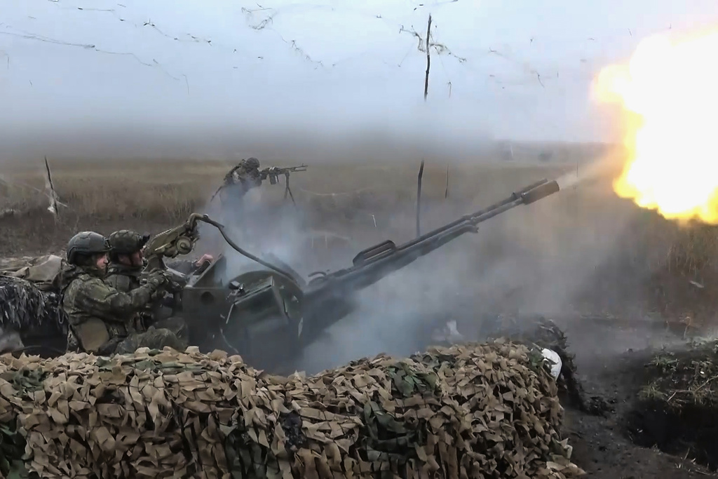Russian army soldiers fire to shoot a Ukrainian drone