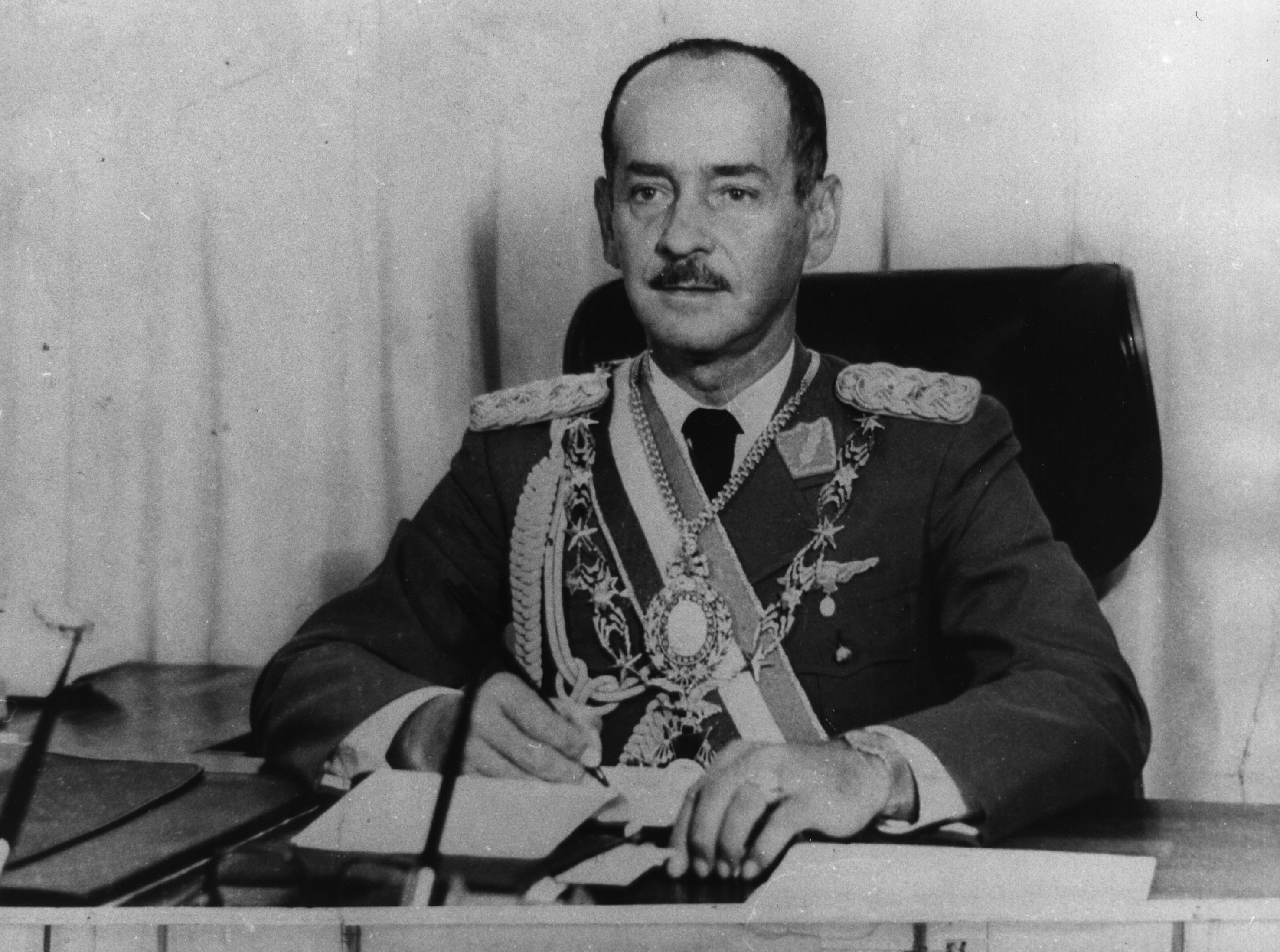 Bolivia’s President Hugo Banzer, whom the US supported, wearing a uniform and decorations at his desk in April 1978