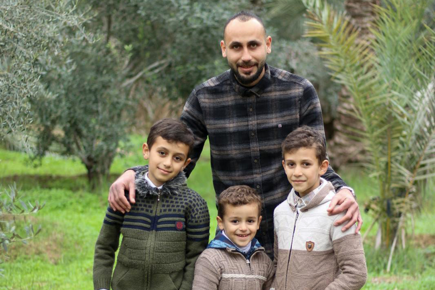 Abdullah, right, his brothers Mahmoud and Mohammad, left, and father Ahmad [Courtesy of Iman Ismail Mohammad Abu Mazid]