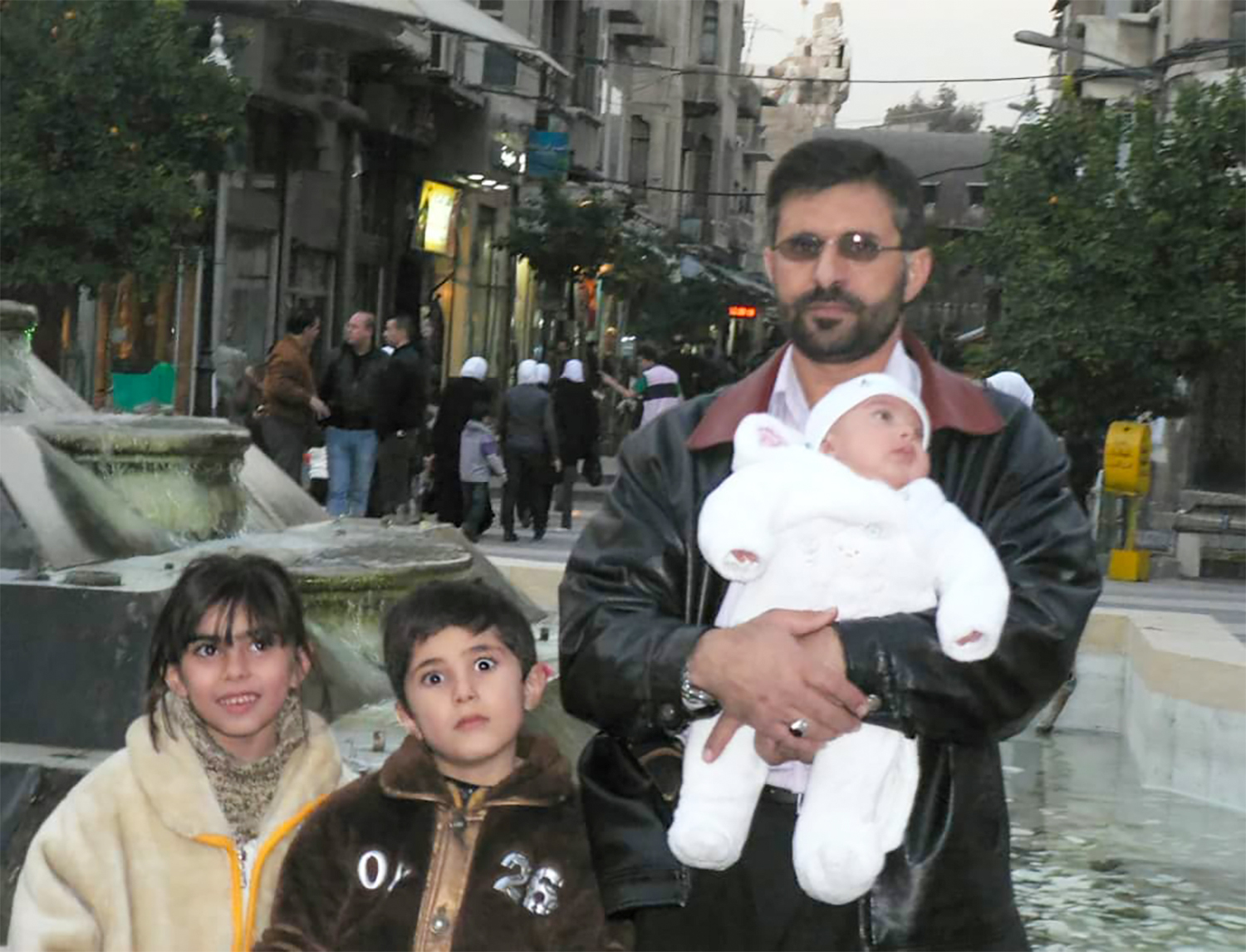Fouziah, Omar and baby Ahmed with their father Mohammed before he was disappeared [Courtesy of Alalawi family]