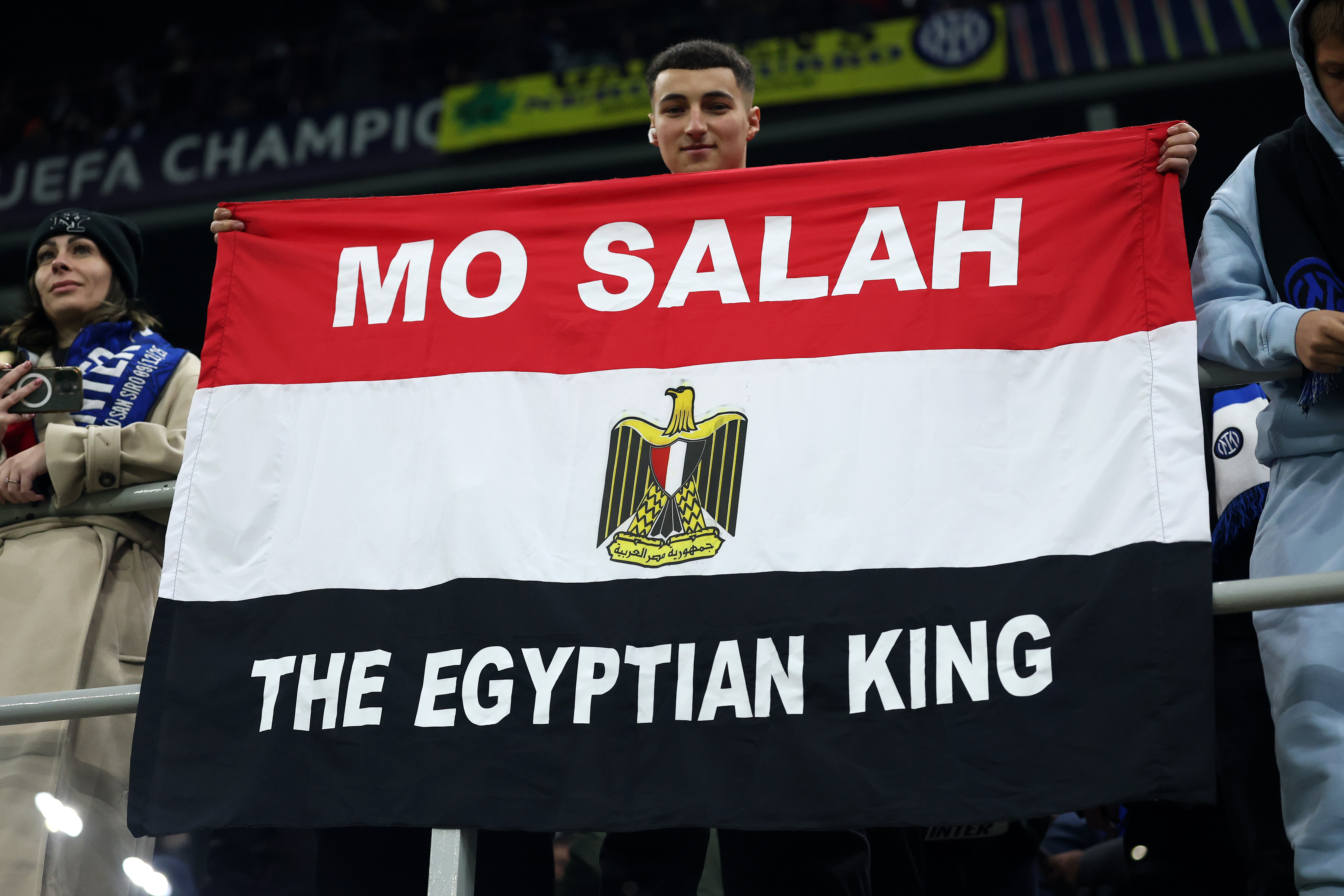 A fan holds a flag in the stands dedicated to Salah during the UEFA Champions League tie between Inter Milan and Liverpool at San Siro Stadium on December 9, 2025 in Milan, Italy