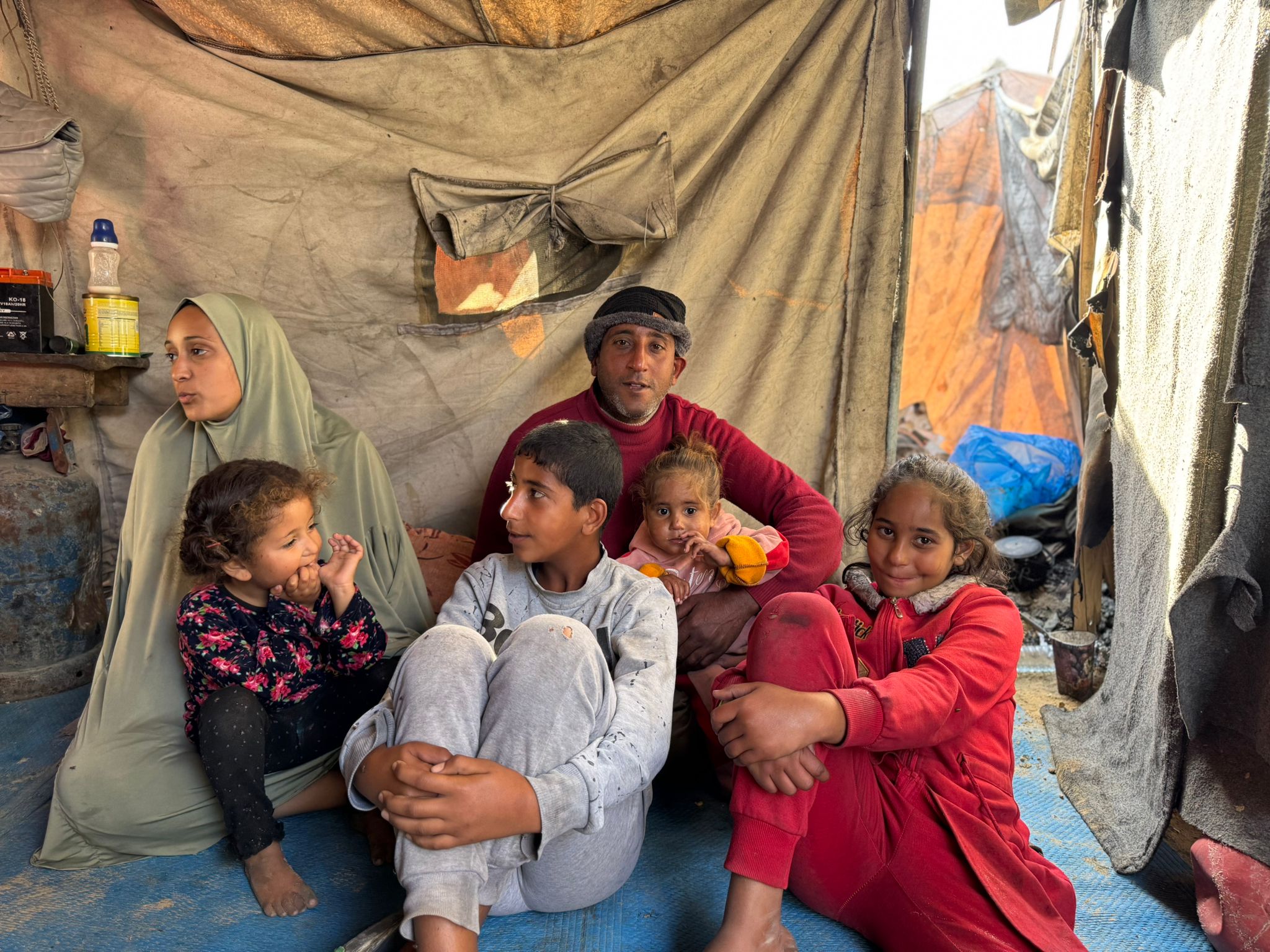 Arafat lives in their tent with 15 members of his family
