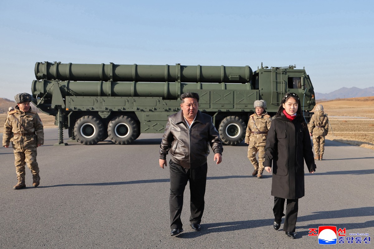 North Korean leader Kim Jong Un and his daughter Kim Ju Ae inspect a test firing of the renewed large-caliber rocket launcher system
