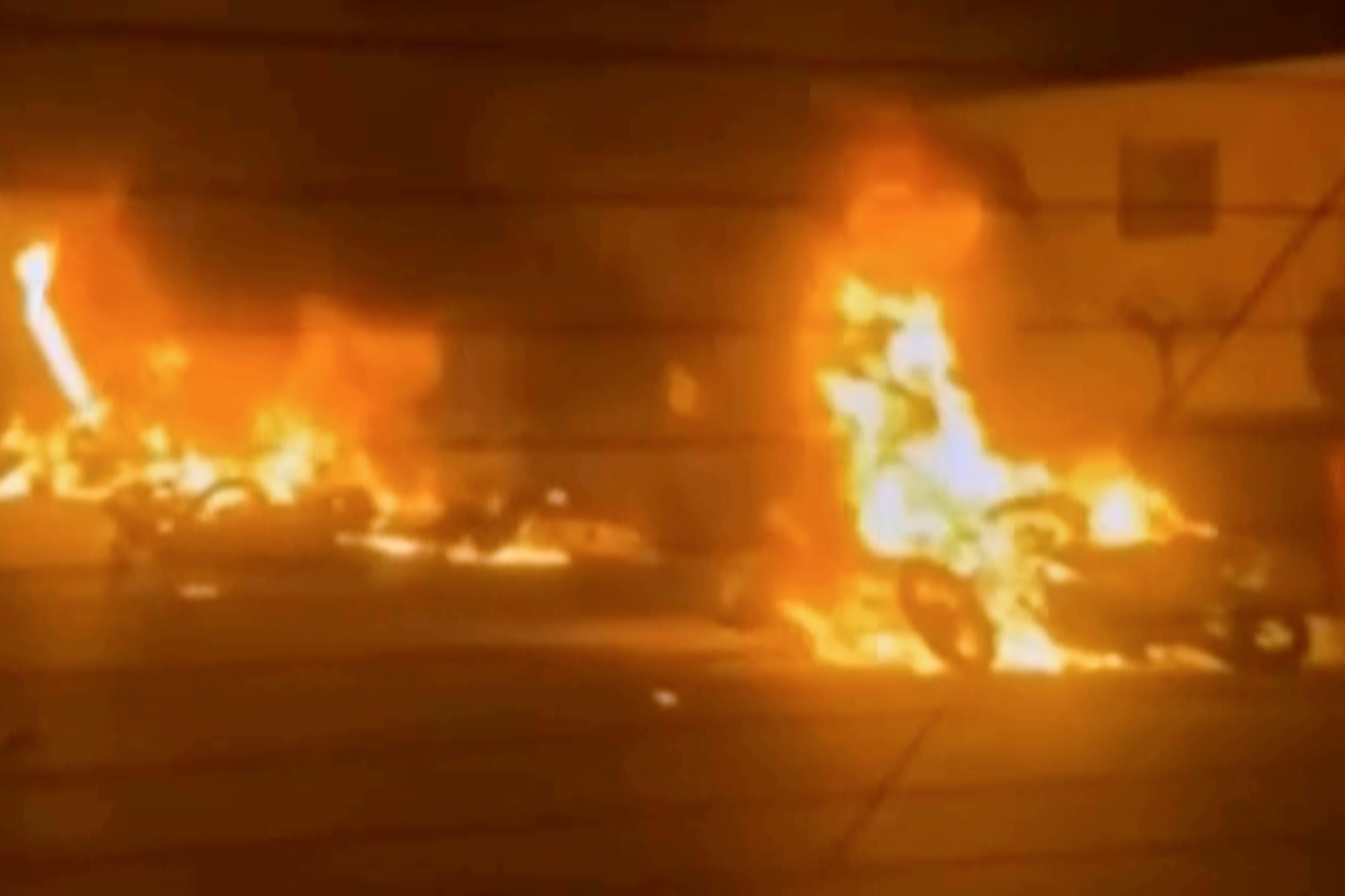 This image from a video released by Iranian state TV shows vehicles burning in Tehran on January 8, 2026