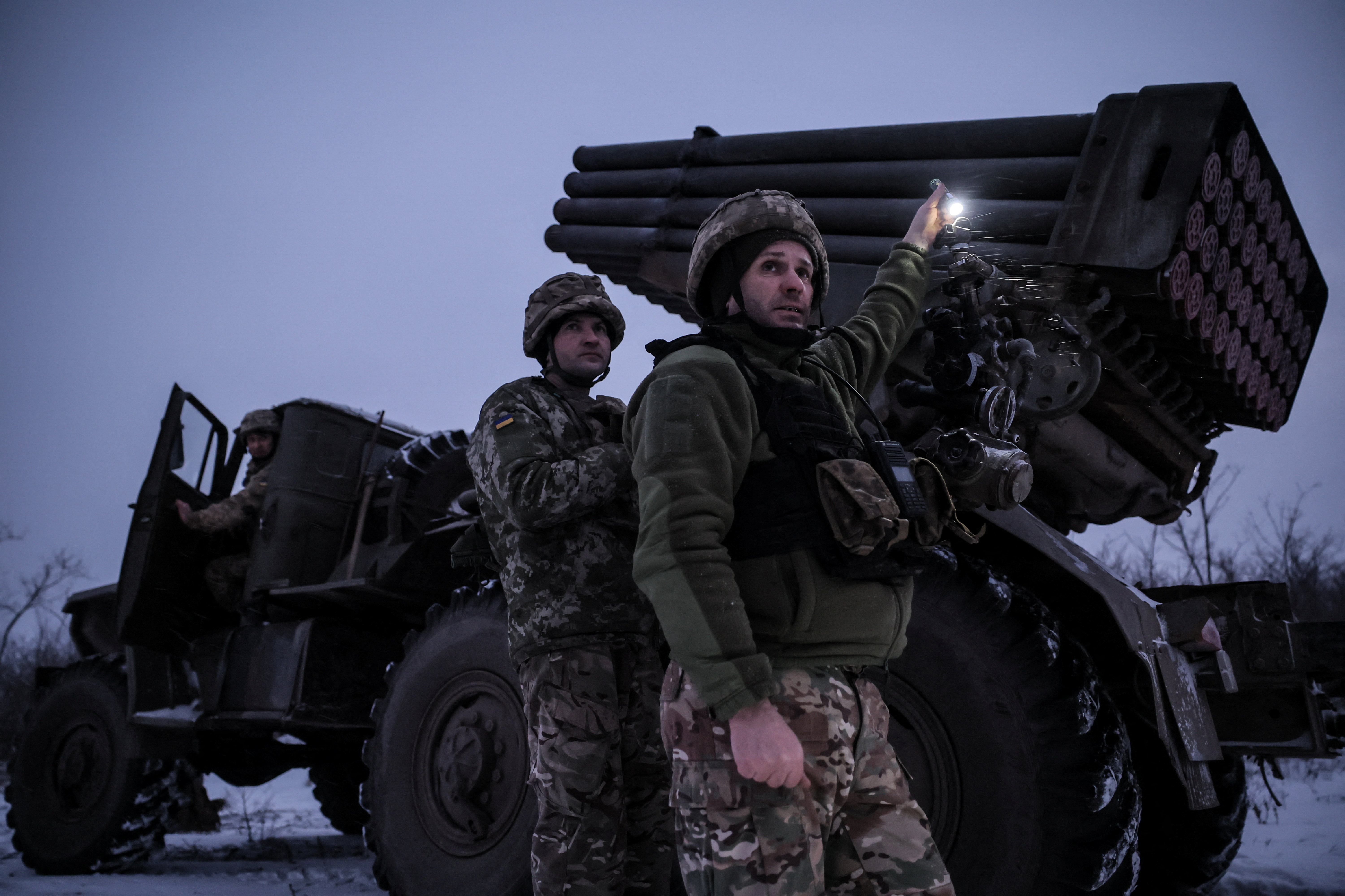 Servicemen prepare to fire a grad rocket.