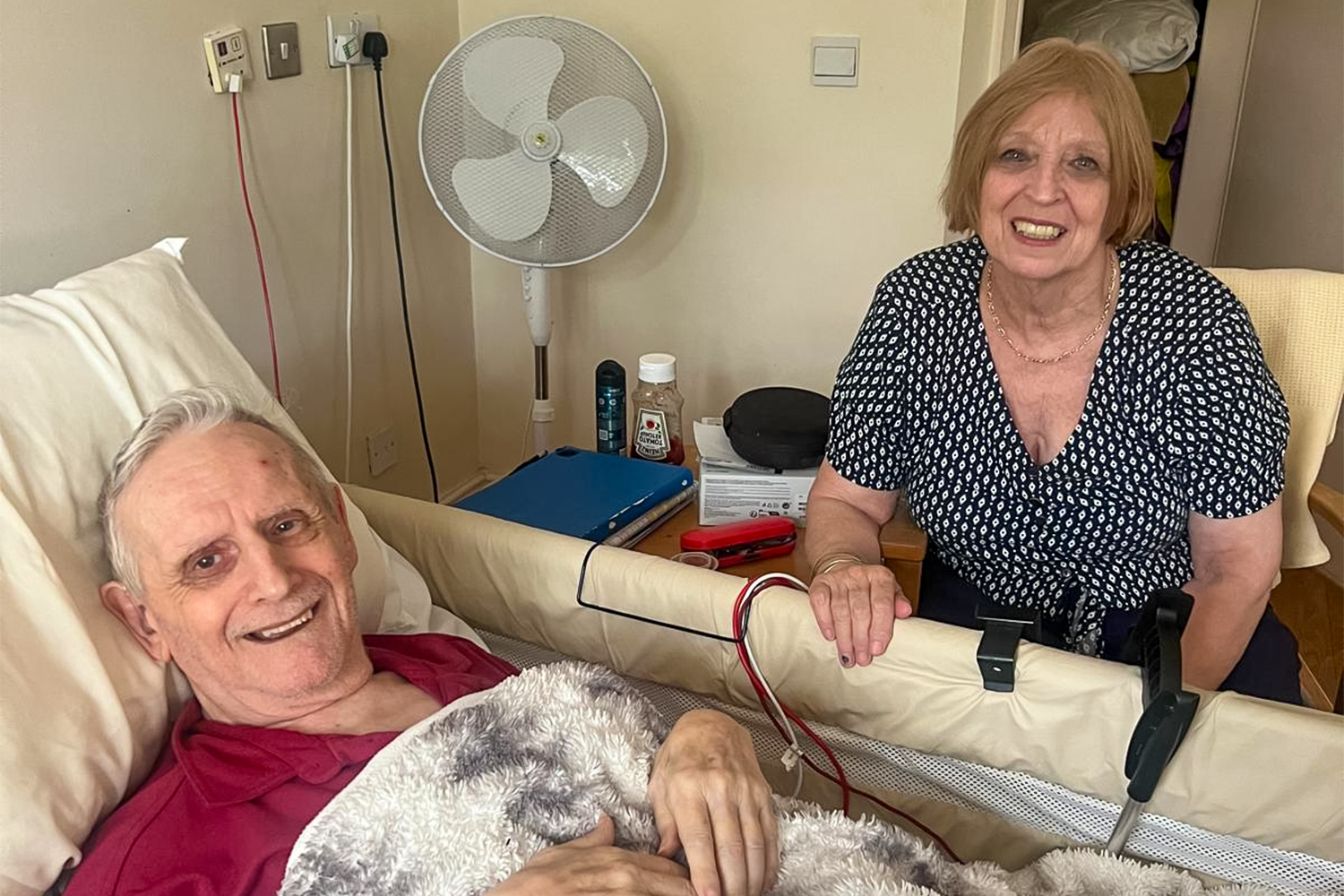 Linda and her husband, John, at the nursing home in 2023, where John was moved after Linda cared for her husband at home for nearly three decades [Courtesy of Linda]