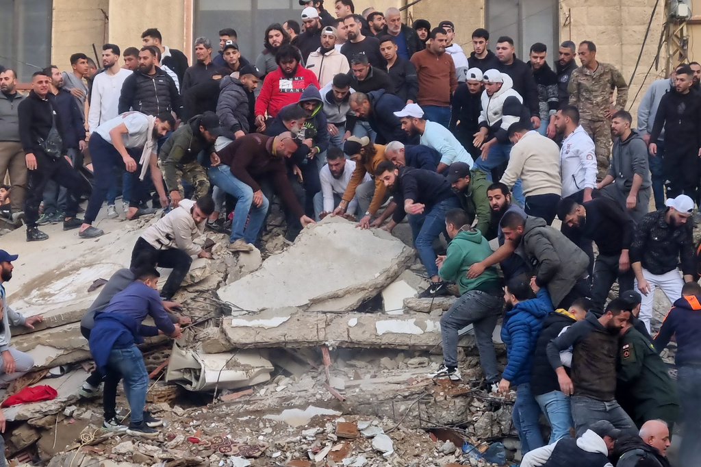Rescue workers and residents search for survivors in the rubble 