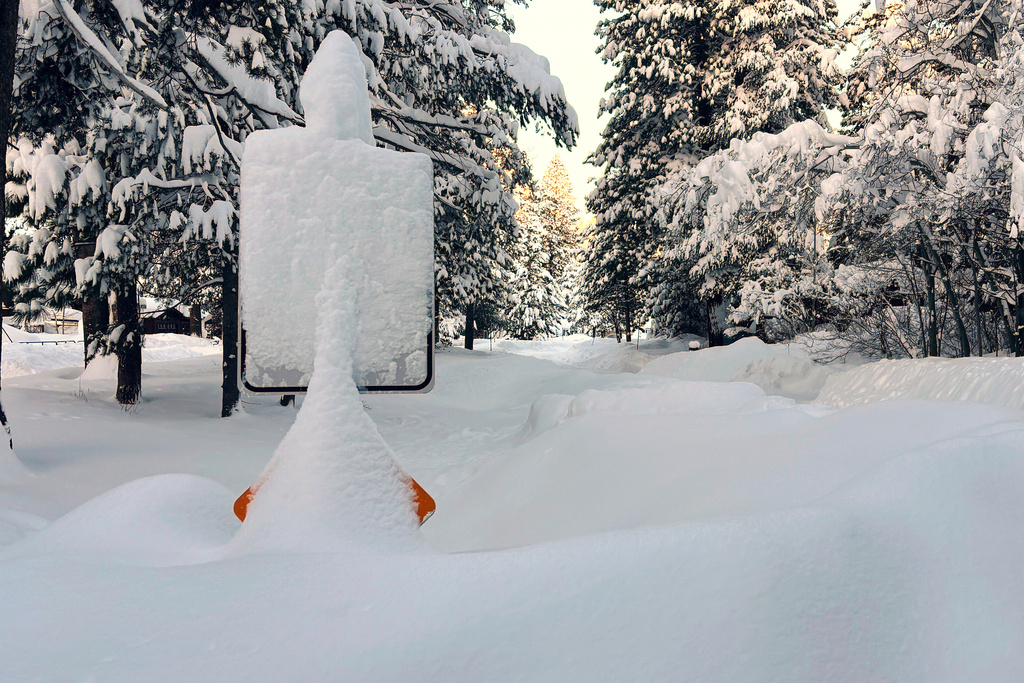 heavy snow covers a sign