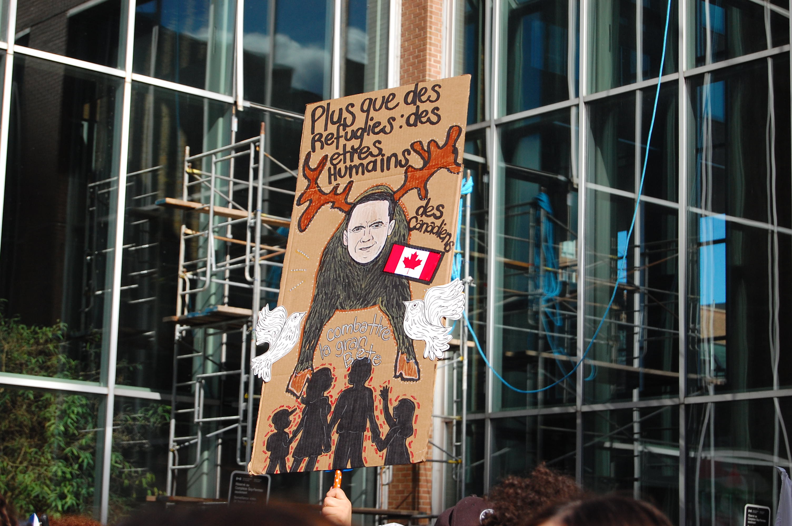 A sign at a refugee and migrant rights rally in Montreal, Canada, reads: 'More than refugees, human beings' 