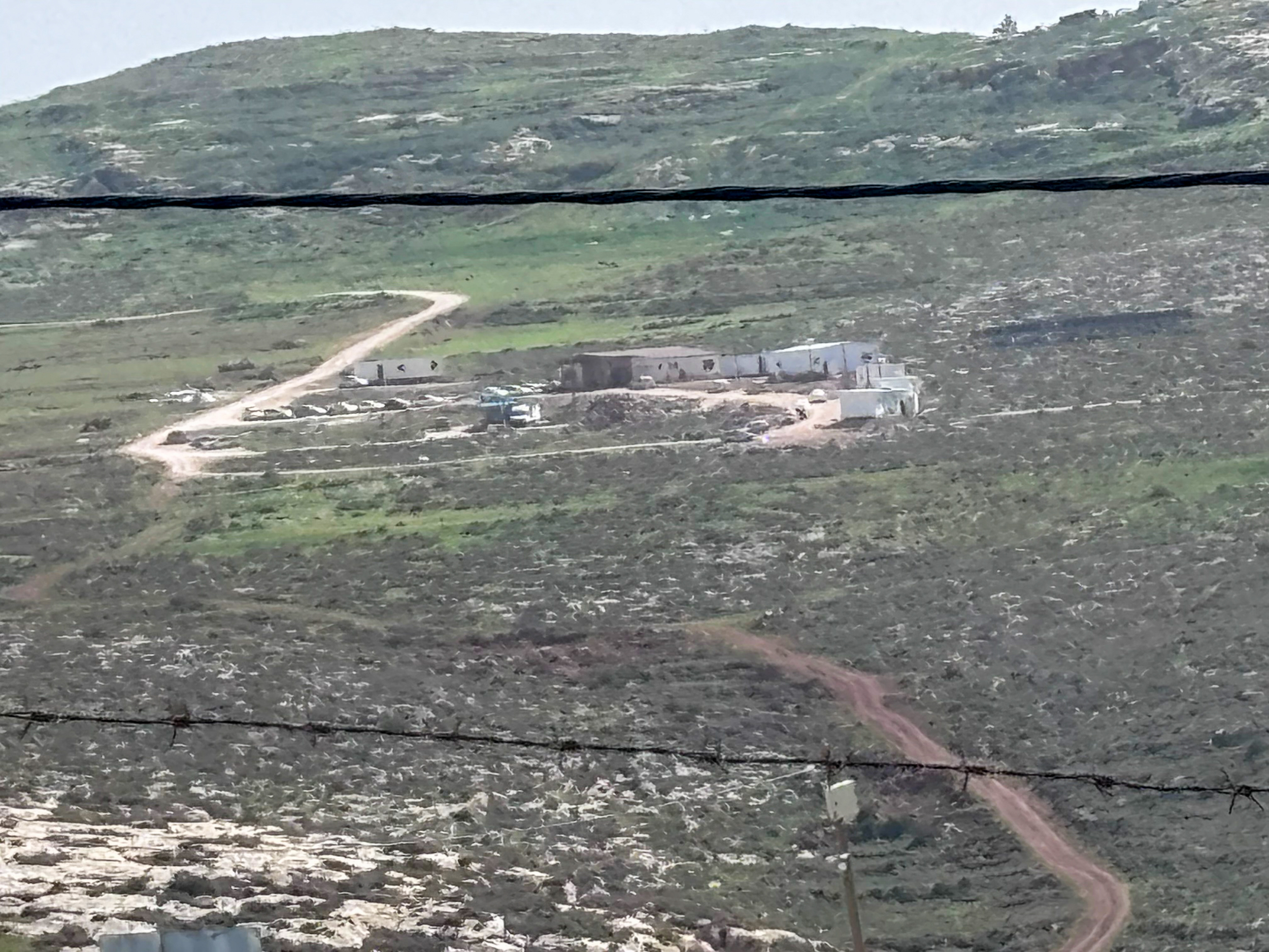 The outpost of the illegal settlement of Malachei HaShalom overlooks the grazing lands around Khirbet al-Marajim, where the Masallam family says escalating settler violence has made life increasingly untenable [Al Jazeera]