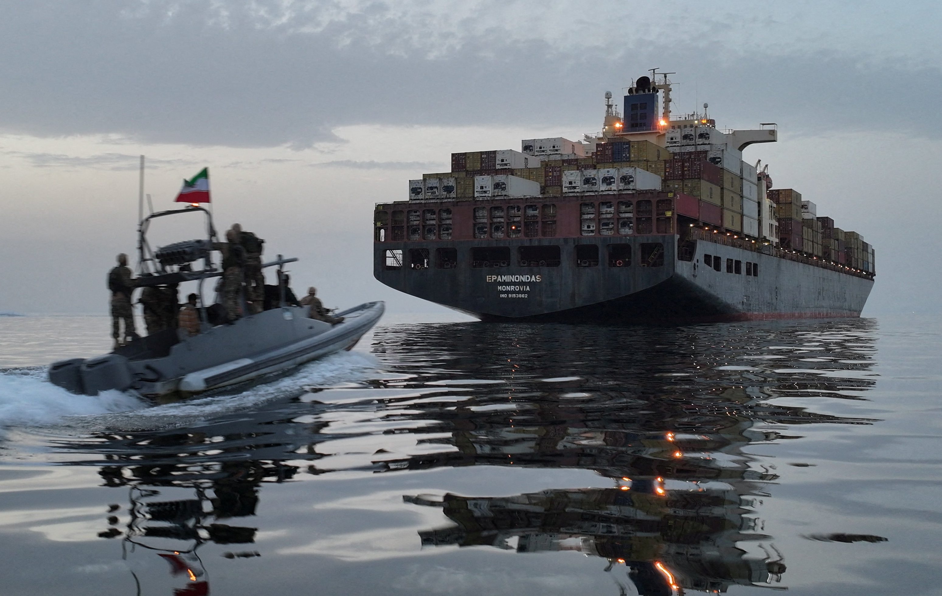 Small boat pursues big ship
