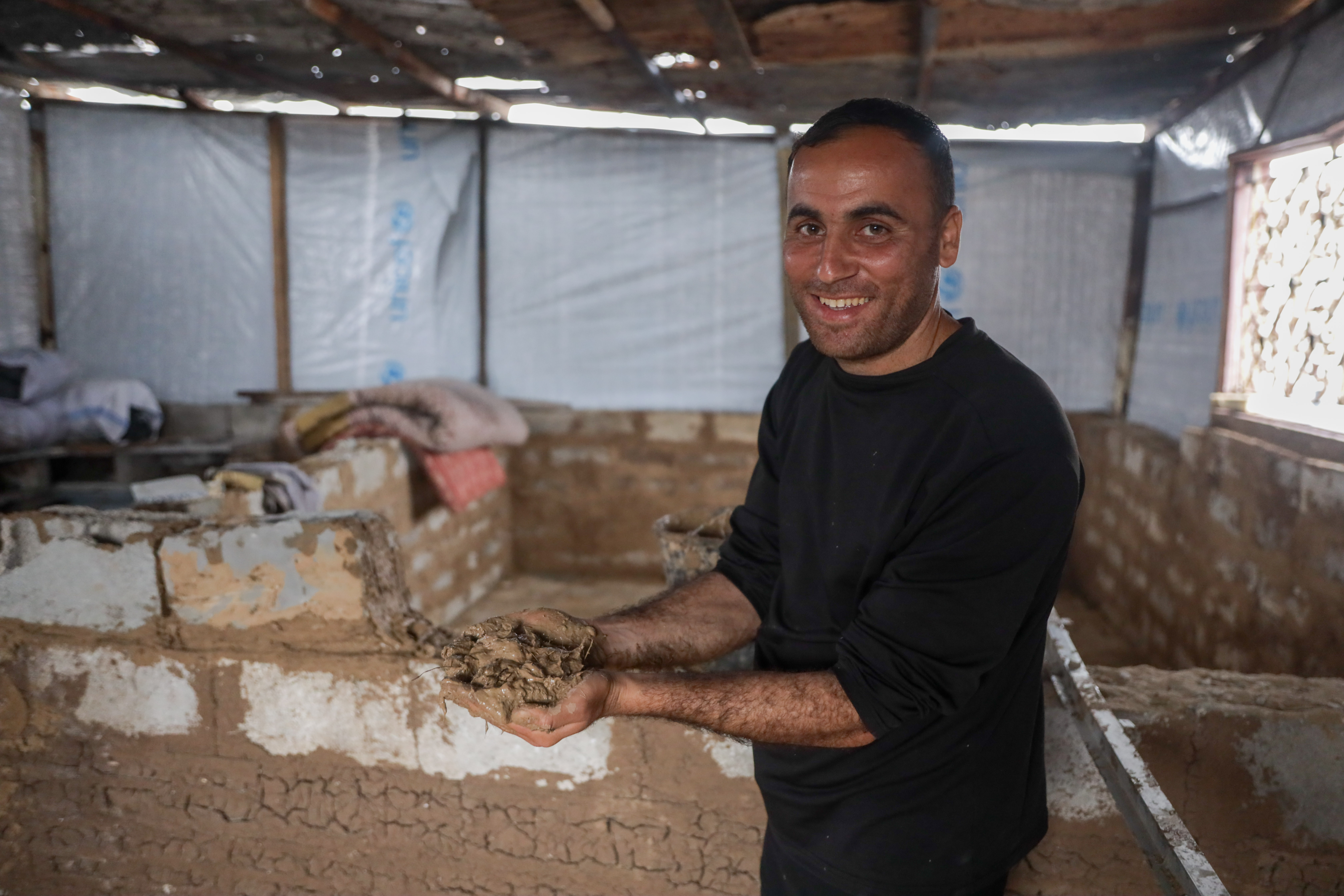 Man holds up mud