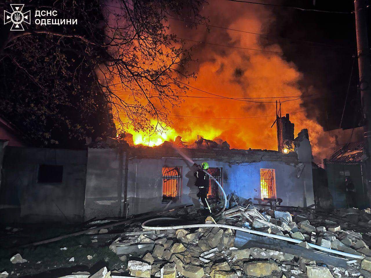 A rescue worker puts out a fire.