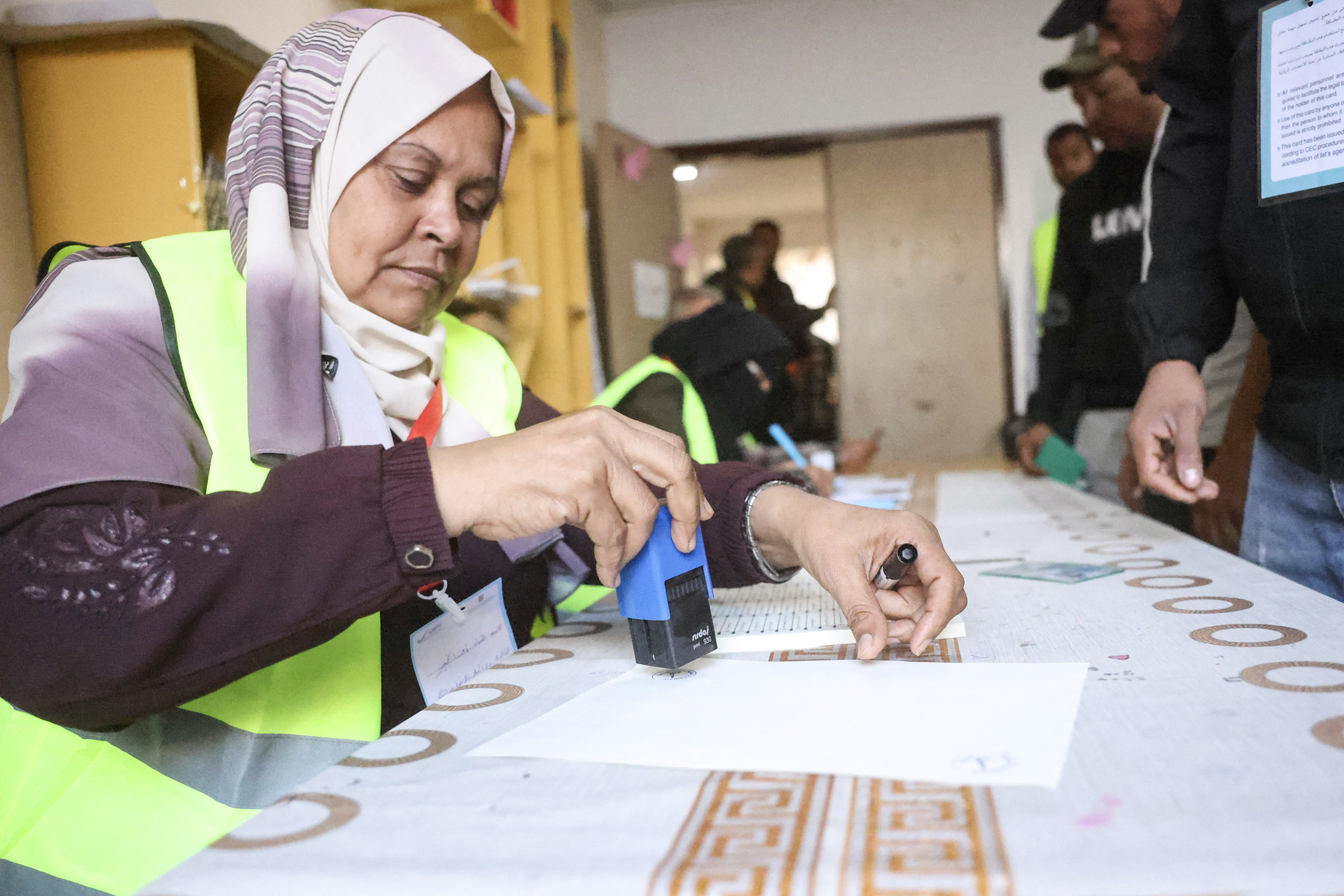 A Palestinian electoral official registers voters before casting their ballots at a polling station during municipal elections in Deir el-Balah, in the central Gaza Strip on April 25, 2026.