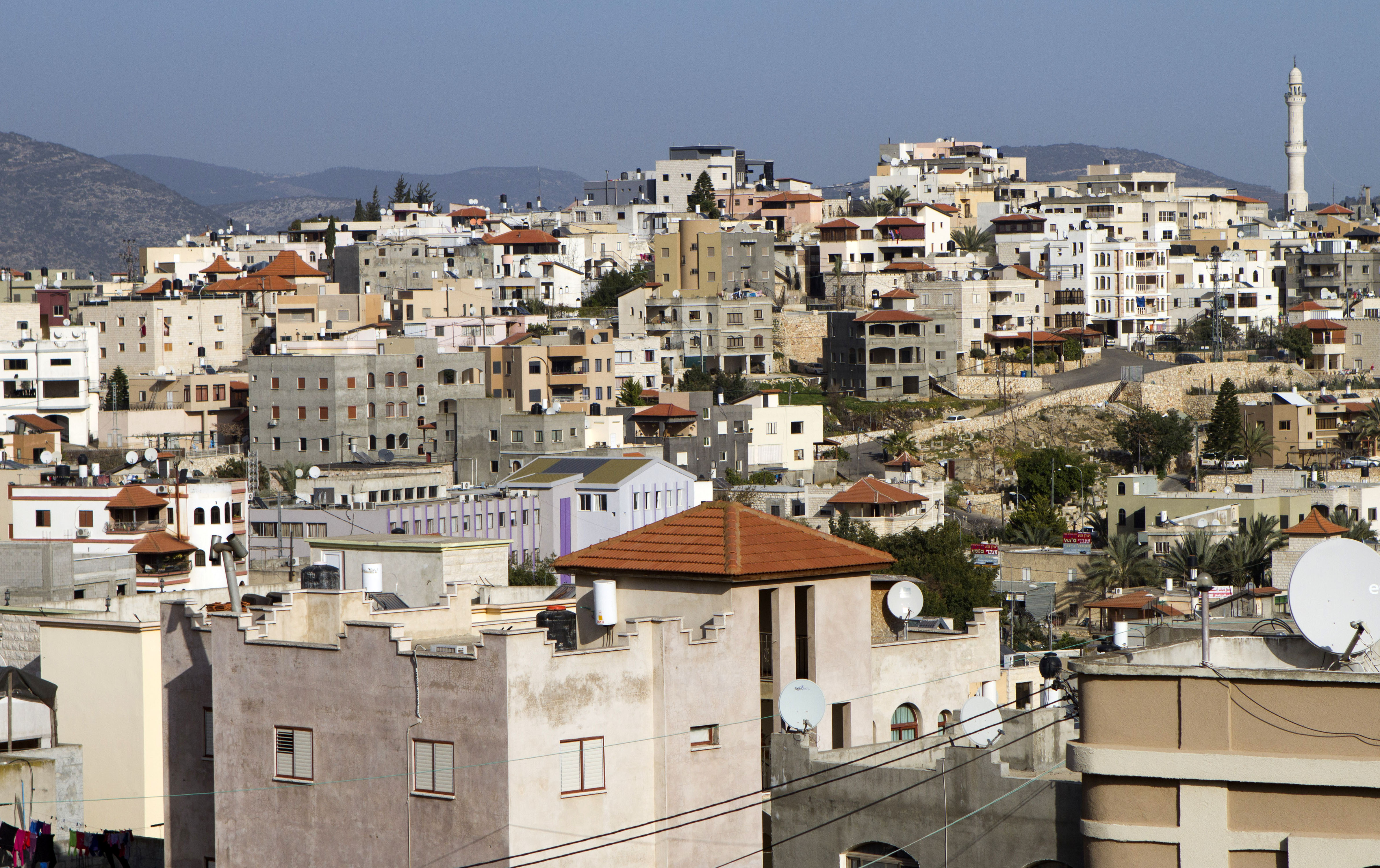 Over view of the Arab city of Sakhnin, about 23 kilometers (14 mi) east of Acre, Israel, Monday, Jan. 26, 2015. Coping with new election laws that make it harder for smaller parties to enter Israel's parliament, the country’s Arab political parties for the first time are banding together under one ticket to boost their chances in upcoming national elections. Arab politicians say it will improve chronically low Arab voter turnout and help block Netanyahu from forming the next government. (AP Photo/Dan Balilty)