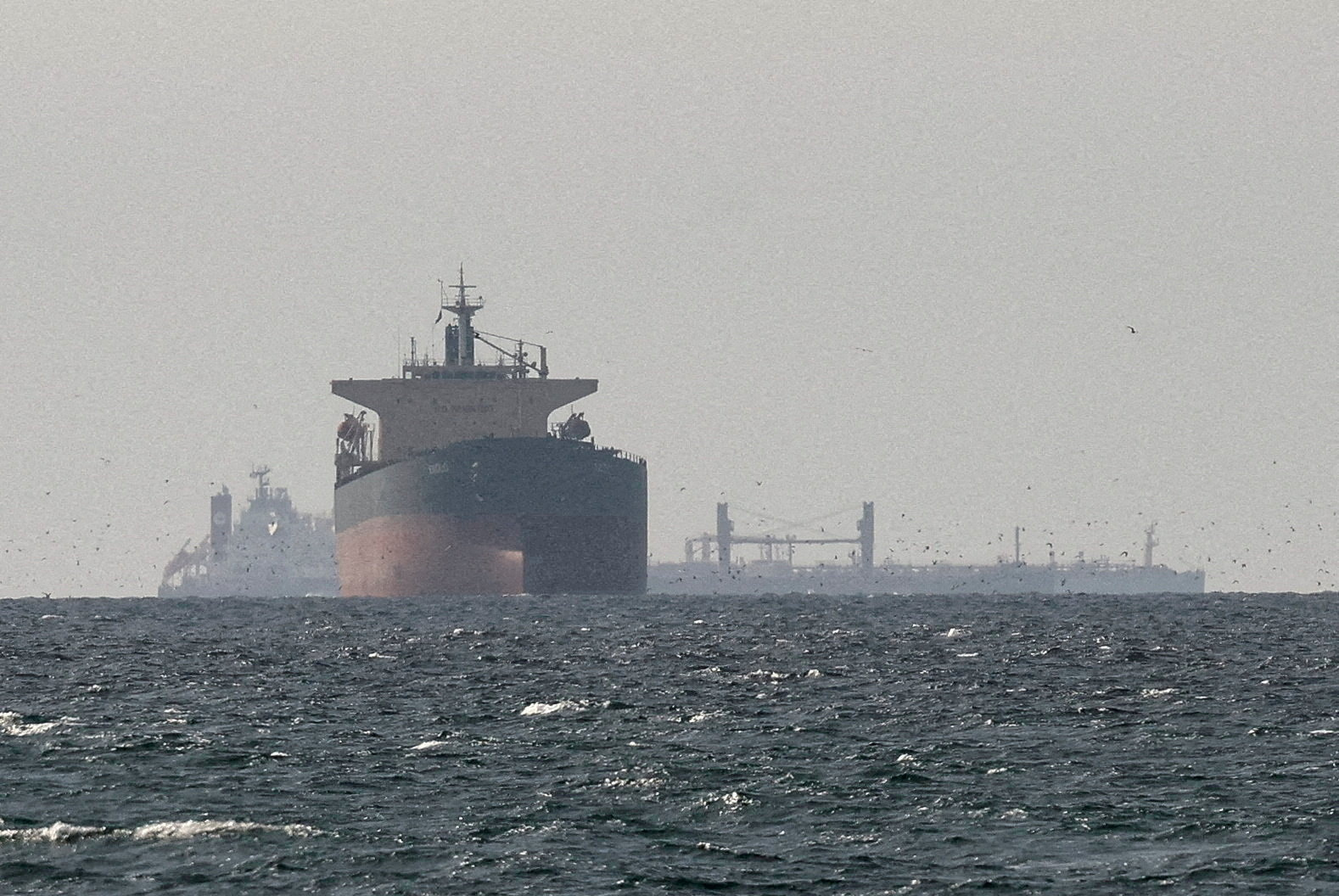FILE PHOTO: FILE PHOTO: Cargo ships in the Gulf, near the Strait of Hormuz, as seen from northern Ras al-Khaimah, near the border with Oman’s Musandam governance, amid the U.S.-Israeli conflict with Iran, in United Arab Emirates, March 11, 2026. REUTERS/Stringer/File Photo/File Photo