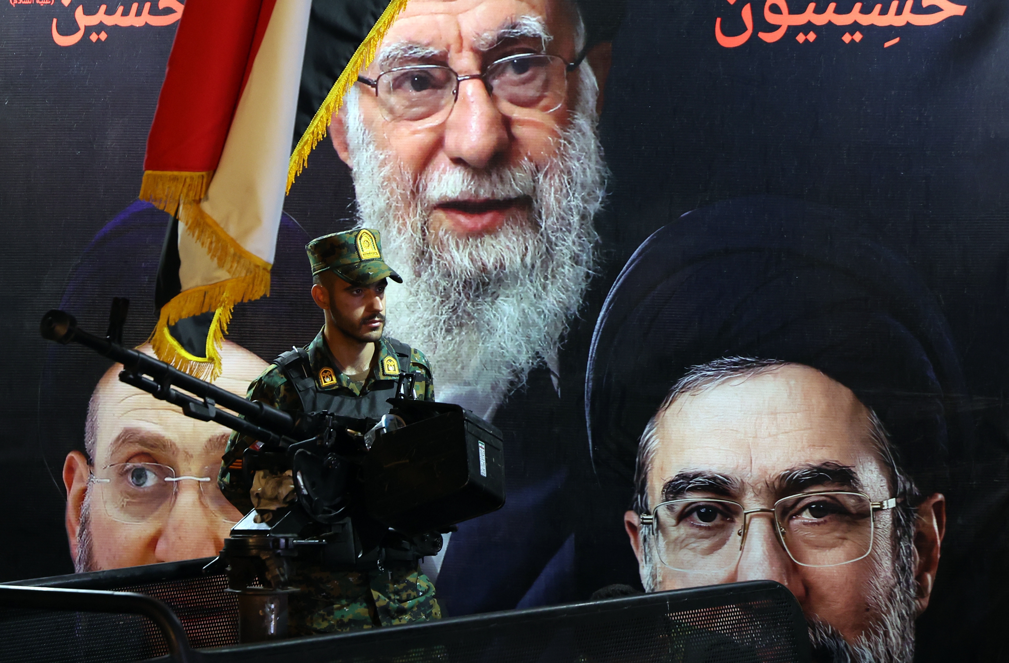 epa12954608 An Iranian military member stands guard in front of the picture of late Iranian supreme leader Ayatollah Ali Khamenei (Top) and Iranian supreme leader Ayatollah Mojtaba Khamenei (R) during a farewell ceremony for Iran's national soccer team in Tehran, Iran, 13 May 2026. Iran's national team will participate in the FIFA 2026 World Cup in the USA. EPA/ABEDIN TAHERKENAREH