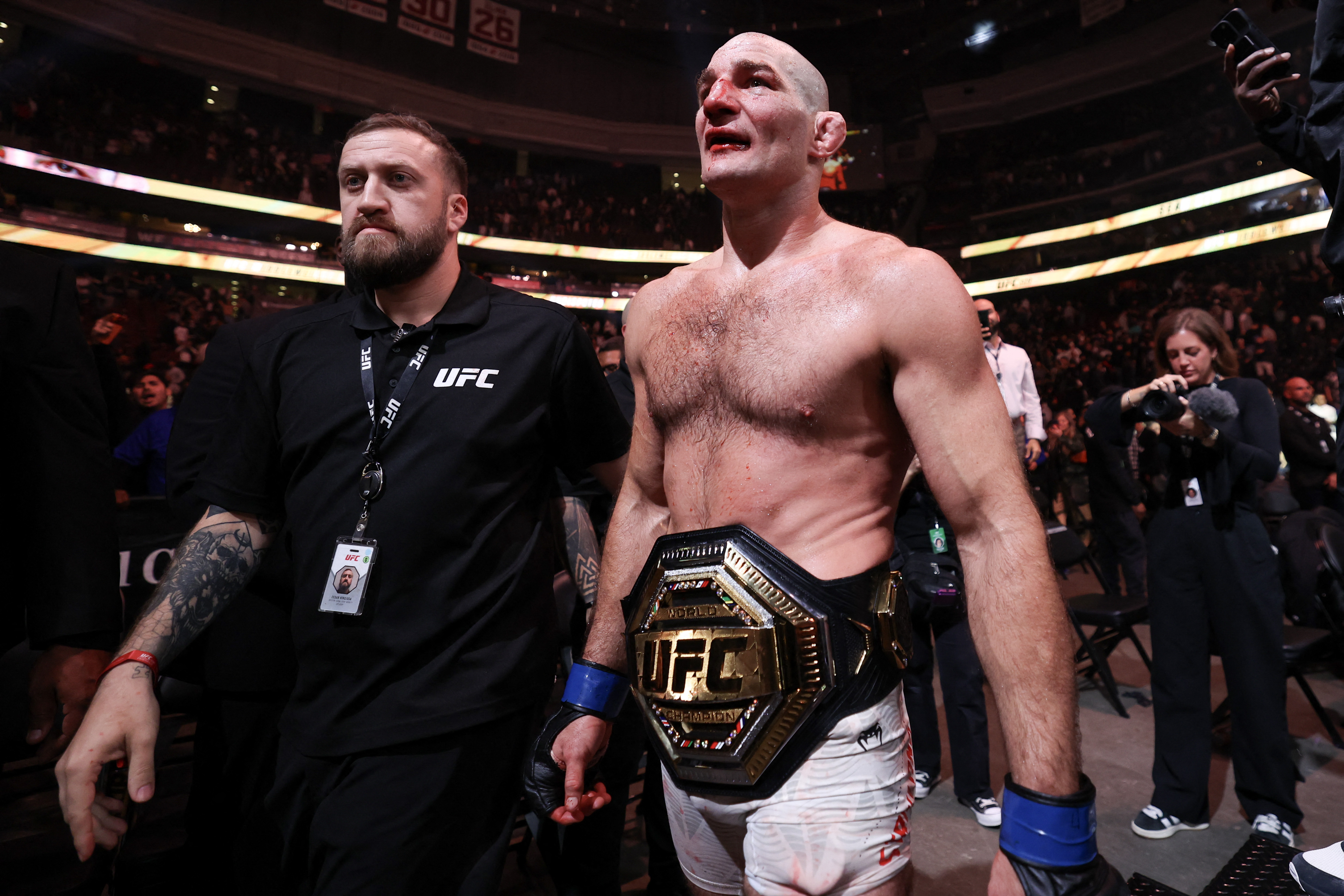Sean Strickland of the US exits the ring after his victory
