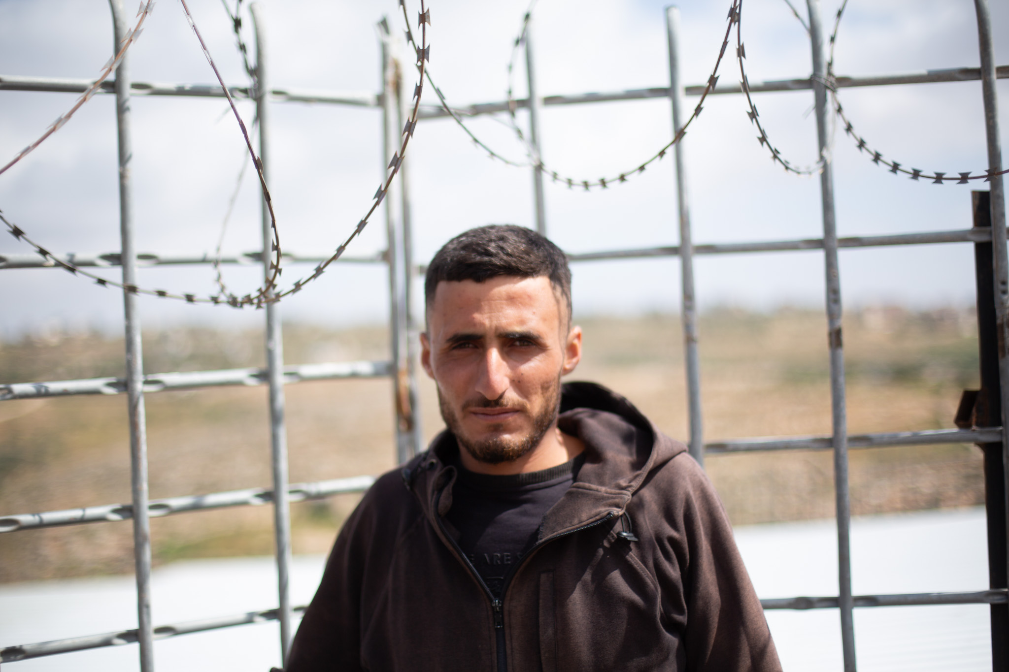 Thabet Masallam beside the family compound in Khirbet al-Marajim, where the Masallams continue resisting pressure to leave their land [Al Jazeera]