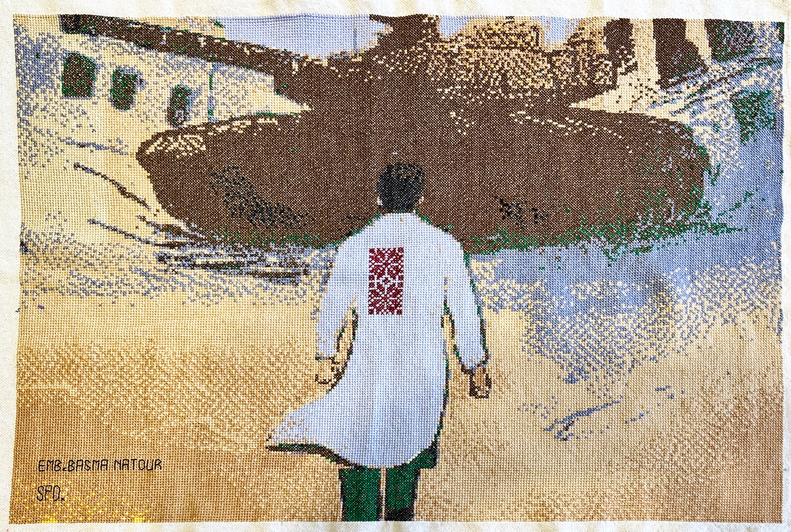 An embroidery of the scene in which Dr Hussam Abu Safiya heads to an Israeli tank