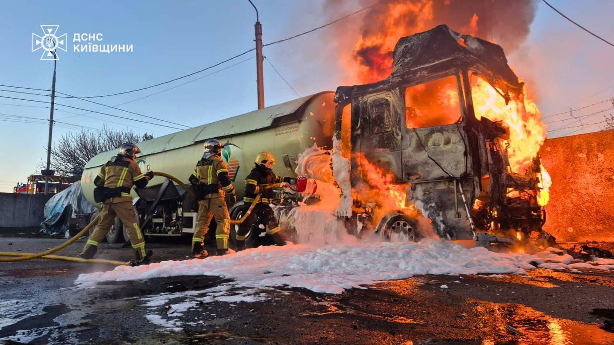 In this photo, provided by the Ukrainian Emergency Service, emergency services personnel work to extinguish a fire a vehicle following a Russian drone attack in Kyiv region, Ukraine, Tuesday, May 5, 2026. (Ukrainian Emergency Service via AP)