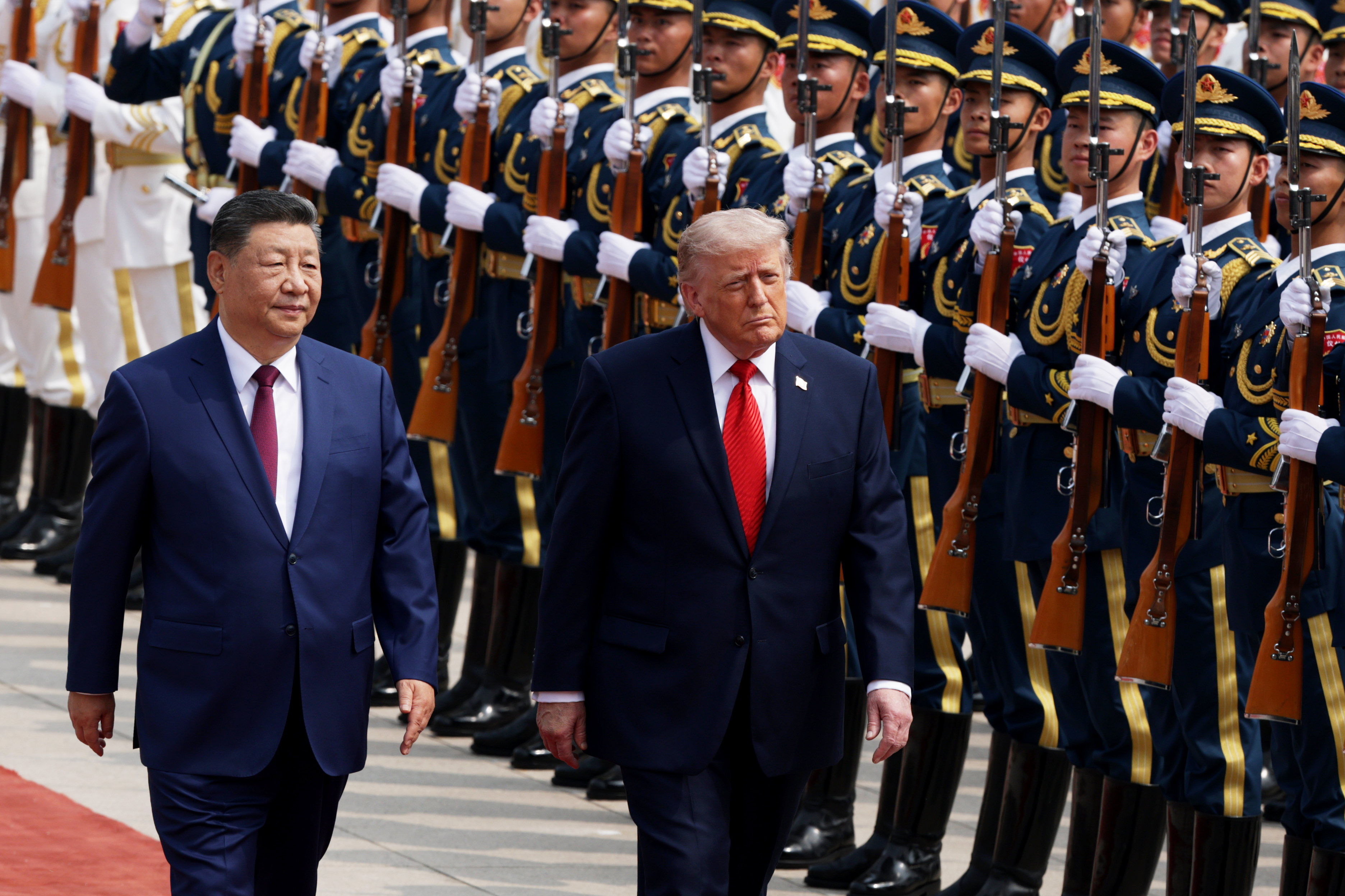 BEIJING, CHINA - MAY 14: U.S. President Donald Trump reviews an honor guard with Chinese President Xi Jinping during a welcome ceremony at the Great Hall of the People on May 14, 2026 in Beijing, China. President Trump is meeting with President Xi Jinping in Beijing to address the Iran conflict, trade imbalances, and the Taiwan situation while establishing new bilateral boards for economic and AI oversight. (Photo by Alex Wong/Getty Images)