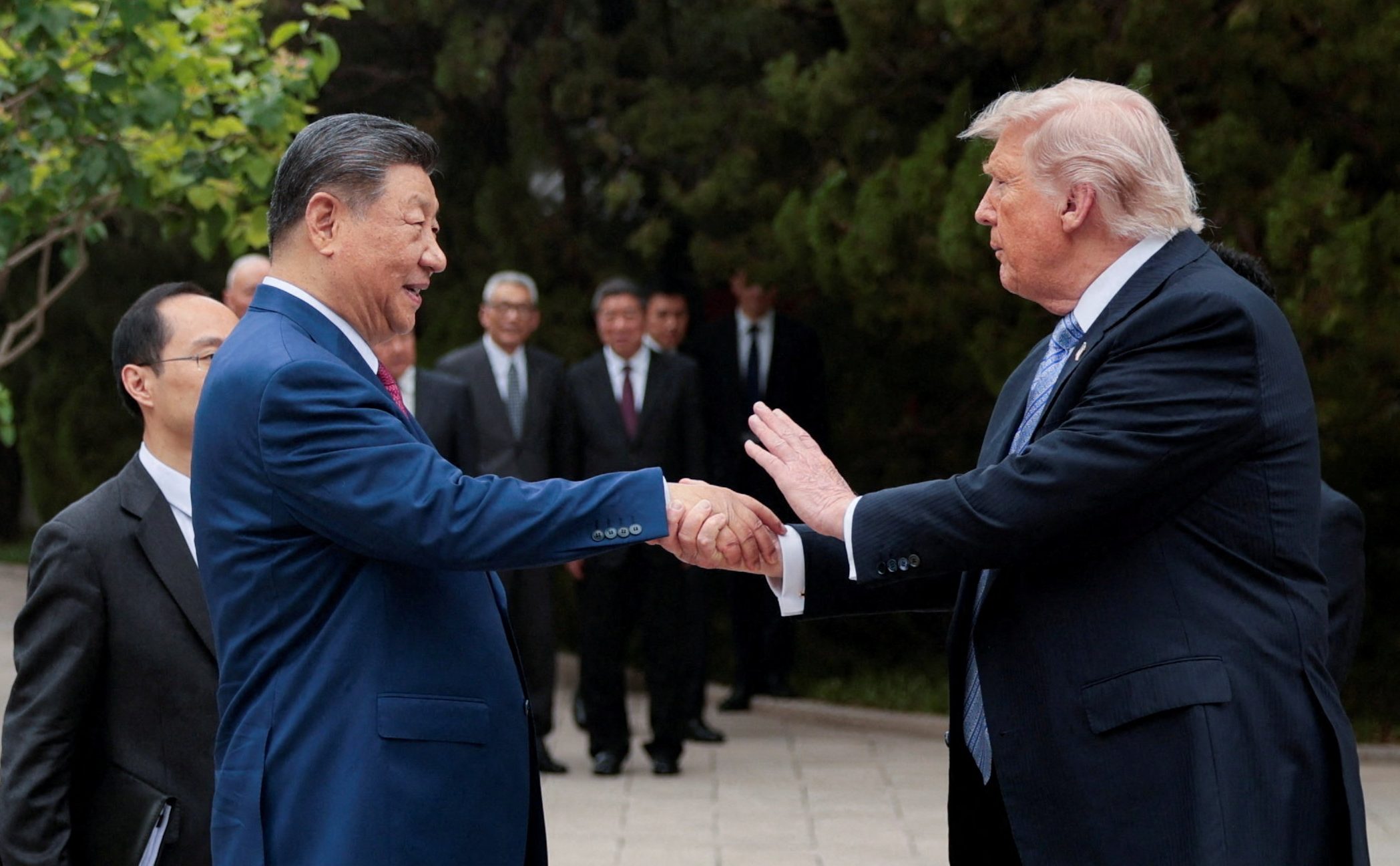 U.S. President Donald Trump speaks with Chinese President Xi Jinping while leaving after a visit to the Zhongnanhai Garden in Beijing, China, May 15, 2026. REUTERS/Evan Vucci/Pool TPX IMAGES OF THE DAY