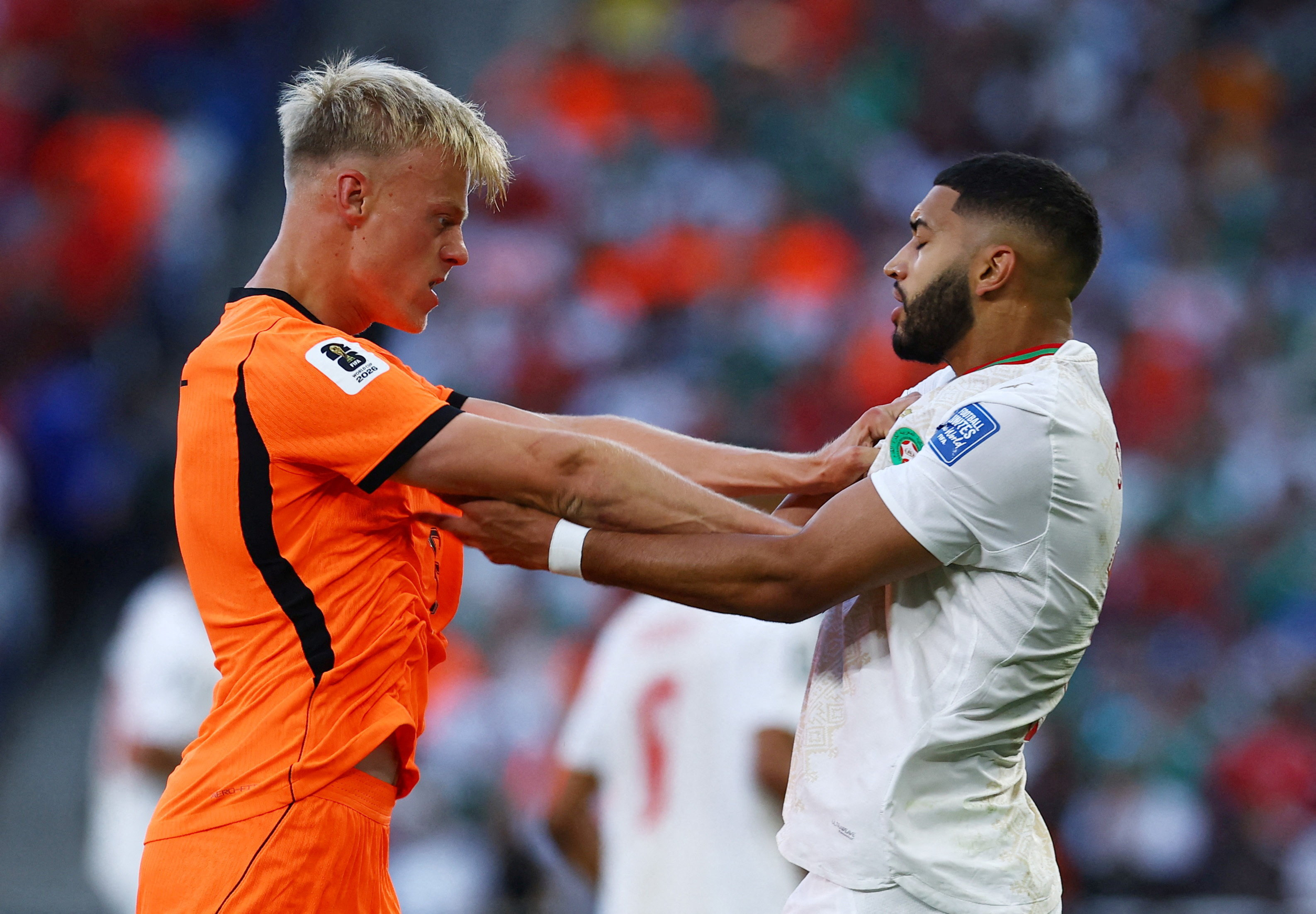 Morocco's Ismael Saibari clashes with Netherlands' Jan Paul van Hecke