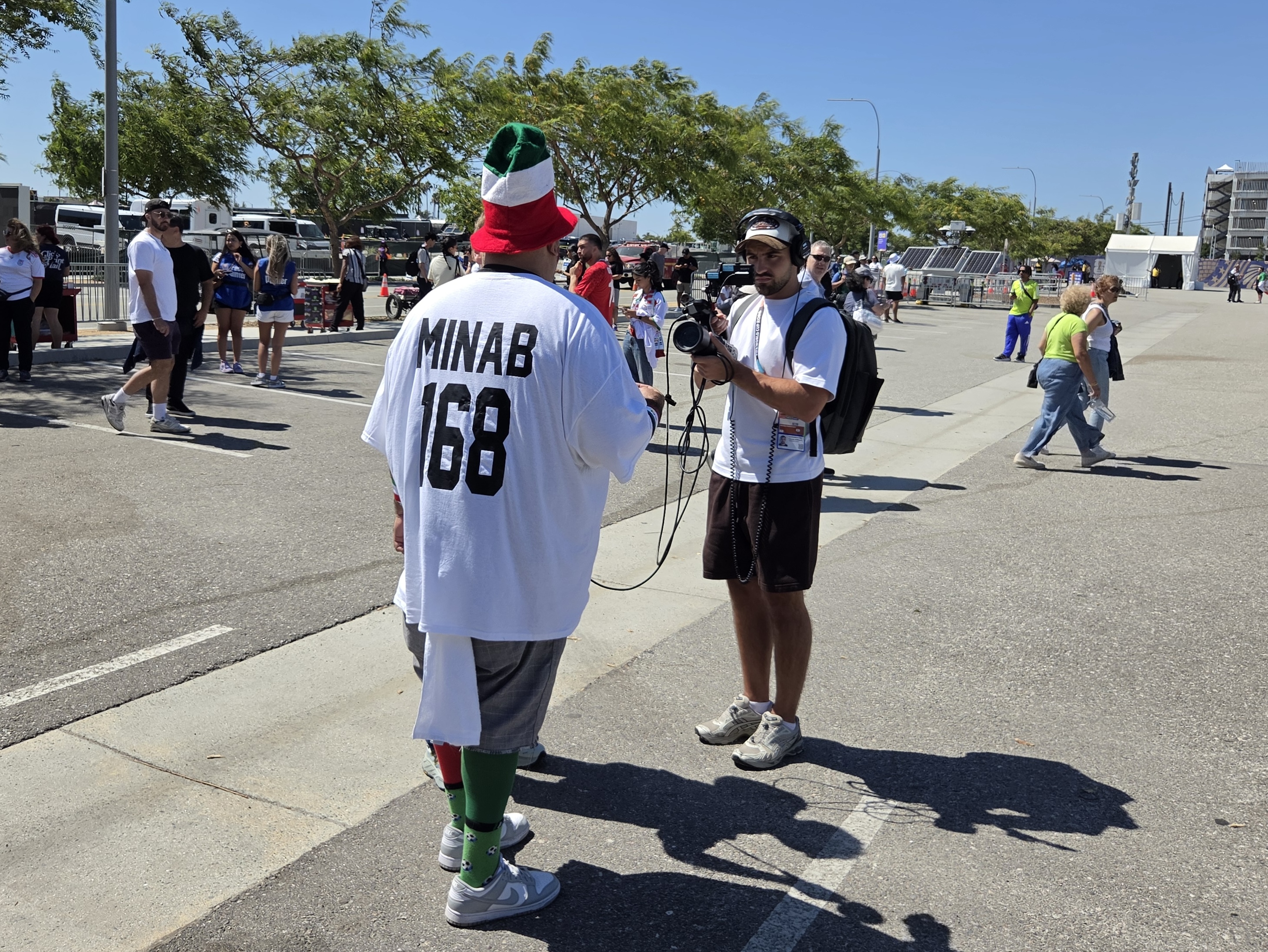 An Iranian fan in Los Angeles wears a shirt that says, ‘Minab 168’