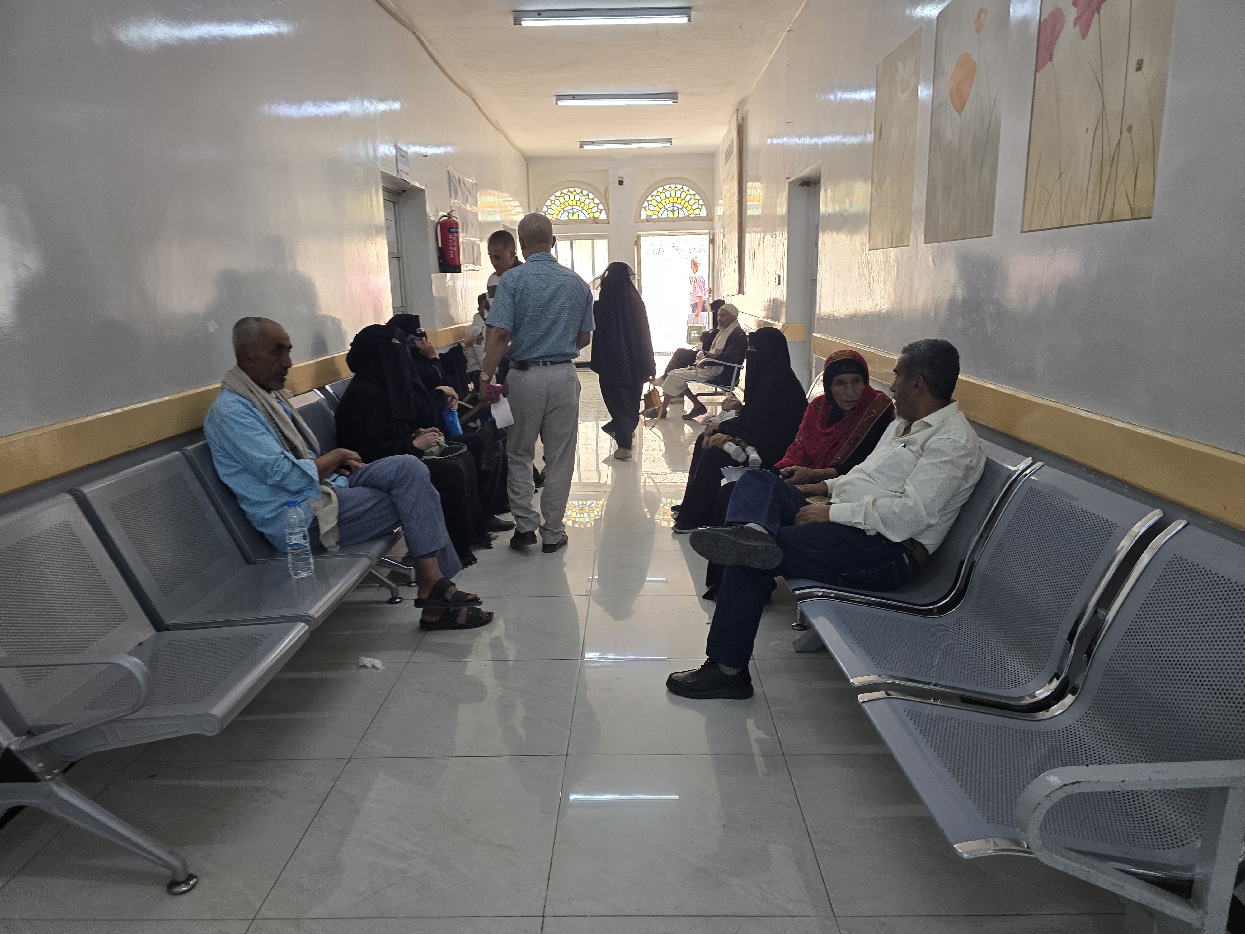 people waiting on chairs in a hospital